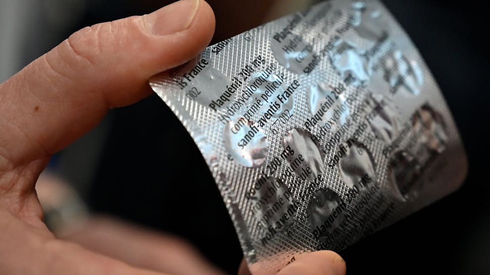 FRANCE-CHINA-HEALTH-VIRUS Medical staff shows on February 26, 2020 at the IHU Mediterranee Infection Institute in Marseille, a packet of Plaqueril, tablets containing hydroxychloroquine, drug that has shown signs of effectiveness against coronavirus. - The Mediterranee infection Institute in Marseille based in La Timone Hospital is at the forefront of the prevention against coronavirus in France.
