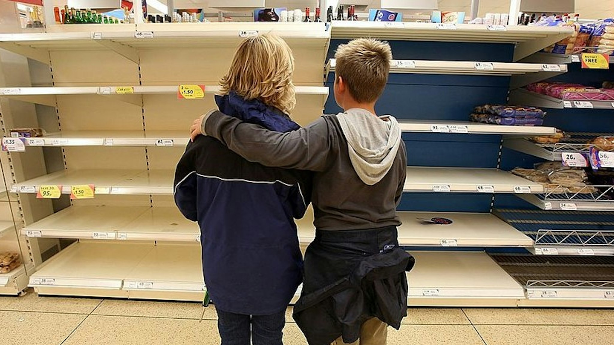 A mother and her son look at the empty bakery shelves in a supermarket on July 23 2007