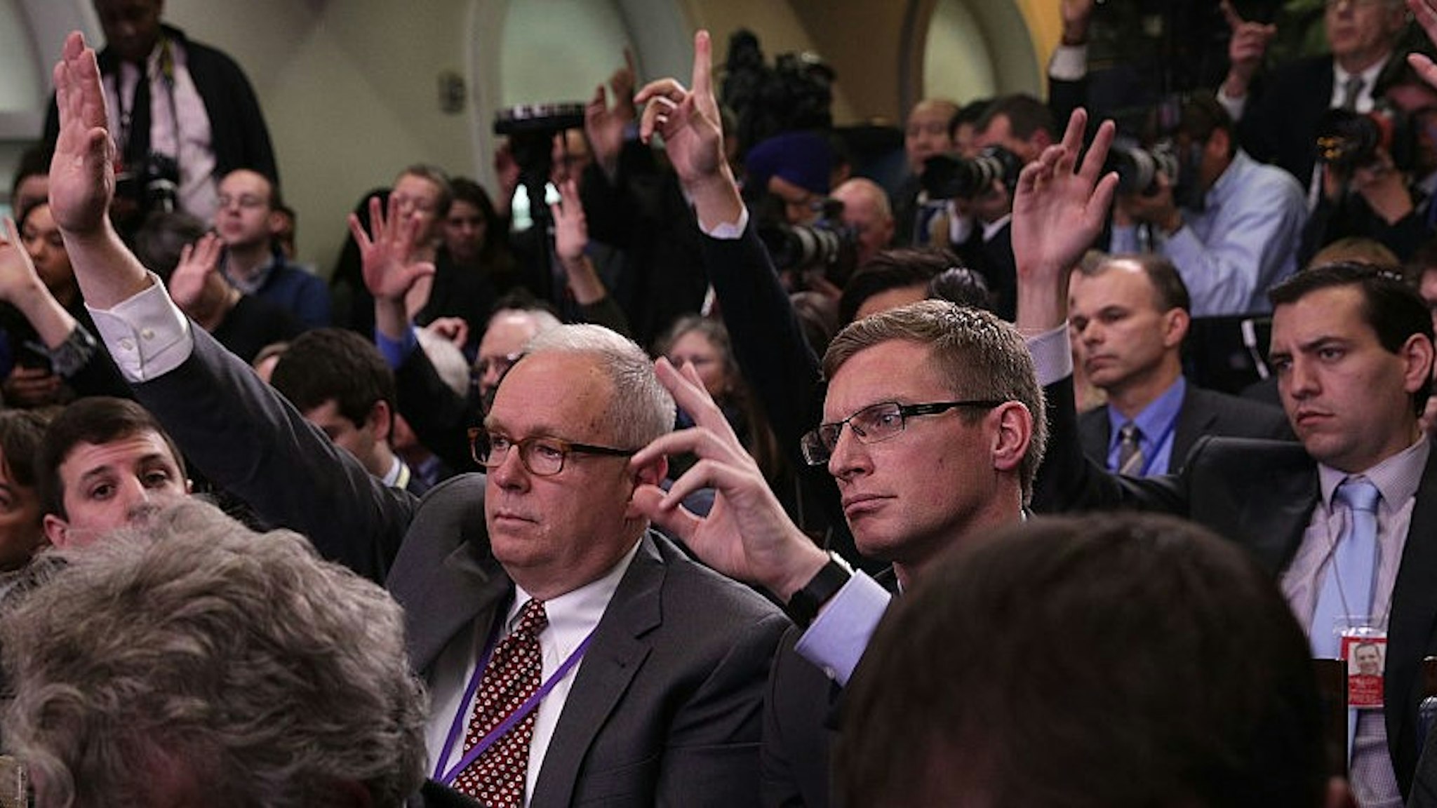WASHINGTON, DC - JANUARY 23: Members of the media raise their hands to ask questions during a daily briefing conducted by White House Press Secretary Sean Spicer at the James Brady Press Briefing Room of the White House January 23, 2017 in Washington, DC. Spicer conducted his first official White House daily briefing to take questions from the members of the White House press corps. (Photo by
