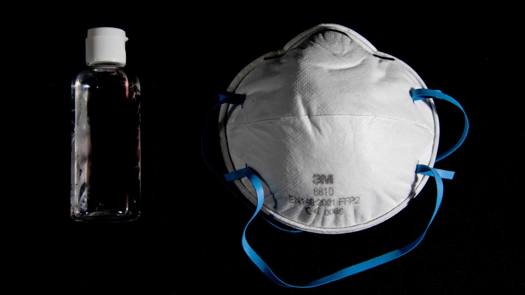 A picture taken on March 4, 2020, in Paris, shows a bottle of alcohol gel hand sanitiser and an FFP2 protective face mask. - Sales of face masks and hand sanitiser have risen and shortages are occuring in countries affected by the spread of COVID-19, the new coronavirus.