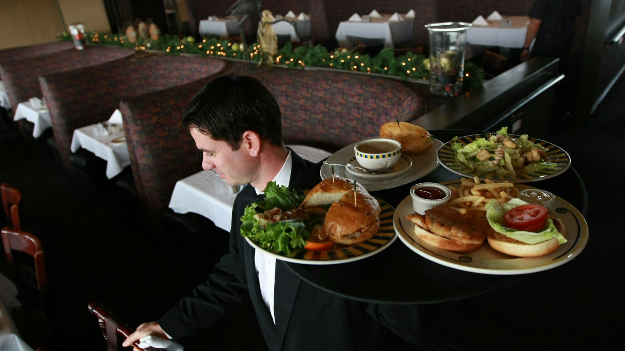 Waiter Alexander Alioto prepares to serve lunch to customers at Alioto's Seafood Restaurant December 3, 2008 in San Francisco, California.