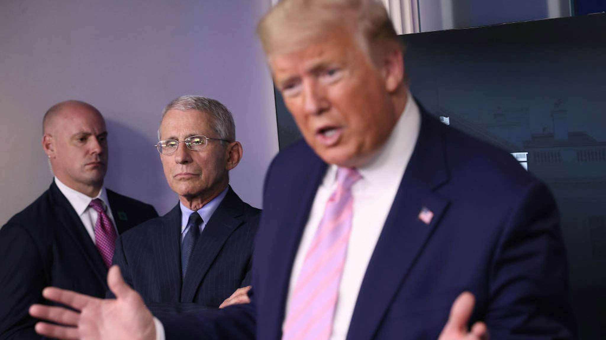 Dr. Anthony Fauci (C) director of the National Institute of Allergy and Infectious Diseases, listens to U.S. President Donald Trump speak from the press briefing room with members of the White House Coronavirus Task Force April 1, 2020 in Washington, DC. After announcing yesterday that COVID-19 could kill between 100,000 and 240,000 Americans, the Trump administration is also contending with the economic effects of the outbreak as the stock market continues to fall, businesses remain closed, and companies lay off and furlough employees. (Photo by Win McNamee/Getty Images)