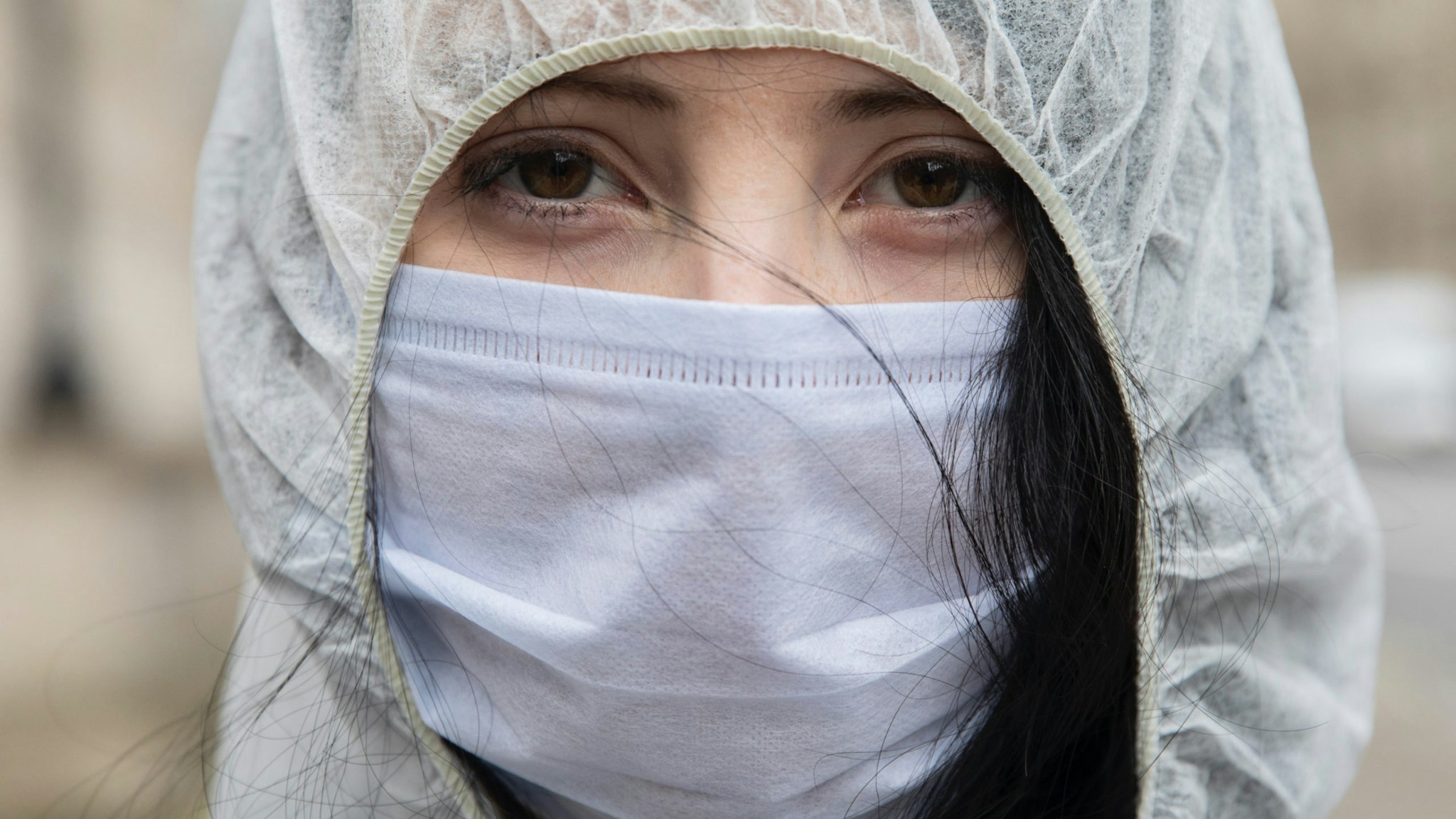A protester wears a face mask outside Downing Street after the weekly cabinet meeting on March 17, 2020 in London, England.