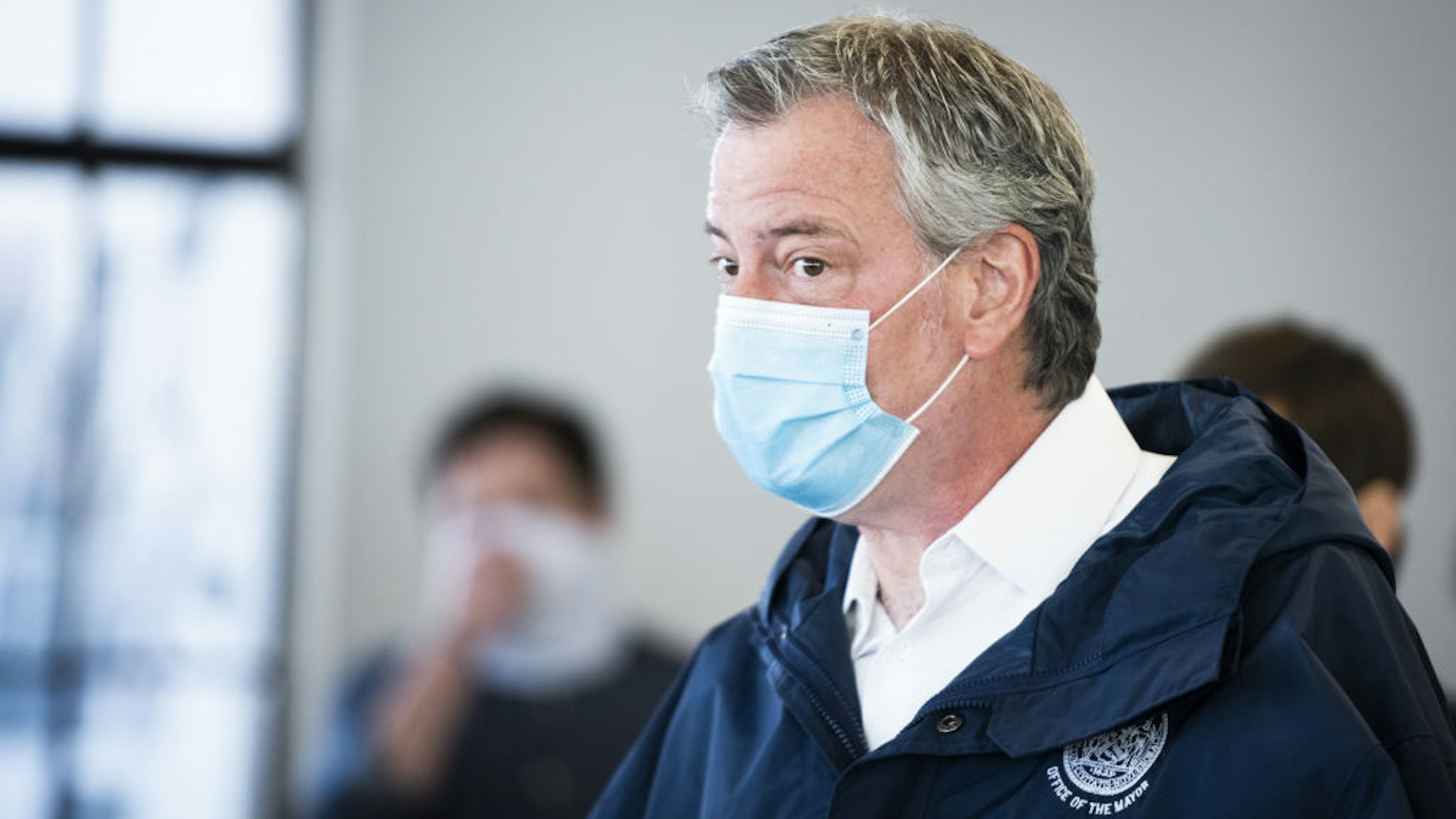 Bill de Blasio, mayor of New York, wears a protective mask while touring the Malia Mills swimwear factory, which has pivoted to manufacturing polypropylene gowns for medical workers, in the Brooklyn borough of New York, U.S., on Wednesday, April 22, 2020. New York City officials intend to enlist thousands of health-care workers next month to conduct hundreds of thousands of diagnostic tests a day, and isolating anyone found to be carrying the disease. Photographer: Mark Kauzlarich/Bloomberg via Getty Images