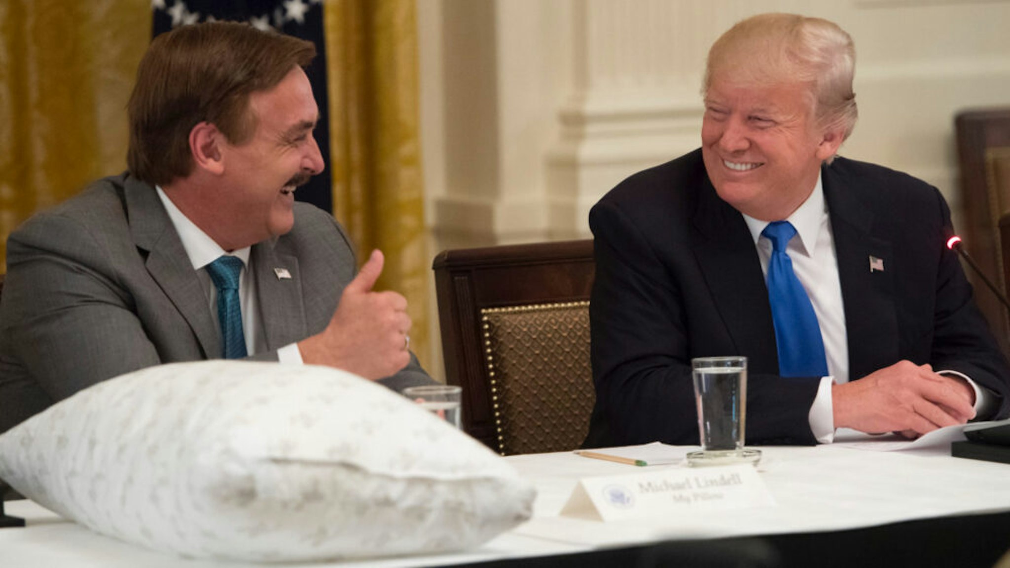 US President Donald Trump speaks alongside Mike Lindell (L), founder of My Pillow, during a Made in America event with US manufacturers in the East Room of the White House in Washington, DC, July 19, 2017.