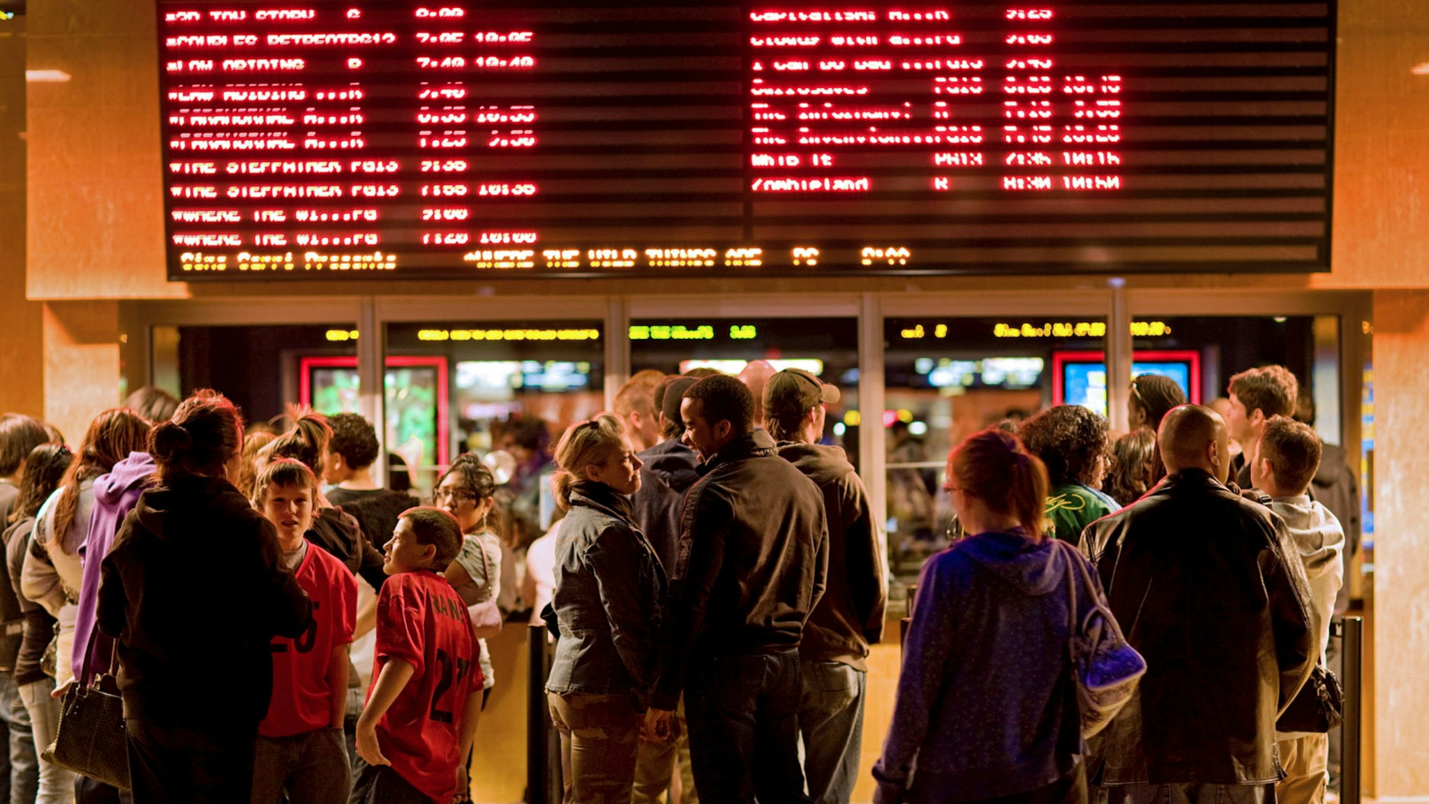 Movie-goers wait in line to buy tickets at a Harkins movie theater in Denver, Colorado, U.S., on Friday, Oct. 16, 2009.