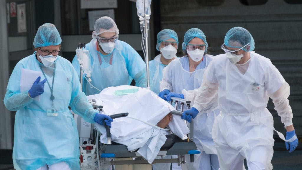 Medical staff push a patient on a gurney to a waiting medical helicopter at the Emile Muller hospital in Mulhouse, eastern France, to be evacuated on another hospital on March 17, 2020, amid the outbreak of the new Coronavirus, COVID-19.