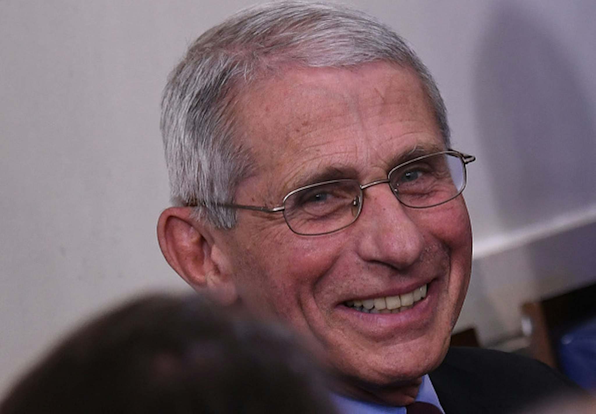 Director of the National Institute of Allergy and Infectious Diseases Anthony Fauci smiles as he listens to US President Donald Trump speak during an unscheduled briefing after a Coronavirus Task Force meeting at the White House on April 5, 2020, in Washington, DC.