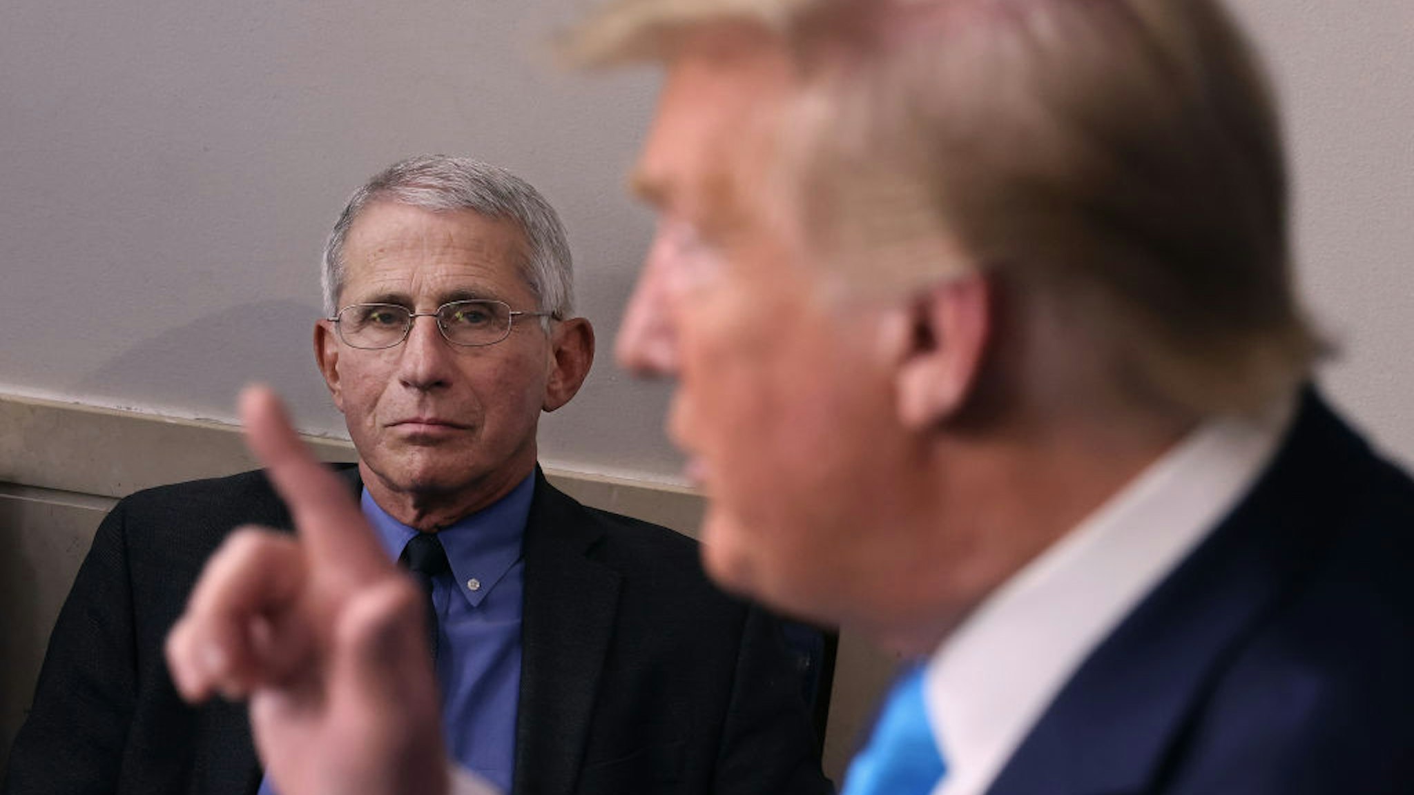 Anthony Fauci, director of the National Institute of Allergy and Infectious Diseases, listens to U.S. President Donald Trump speak to reporters following a meeting of the coronavirus task force in the Brady Press Briefing Room at the White House on April 7, 2020 in Washington, DC. The president today removed the independent chairman of a committee tasked with overseeing the roll out of the $2 trillion coronavirus bailout package. (Photo by Chip Somodevilla/Getty Images)