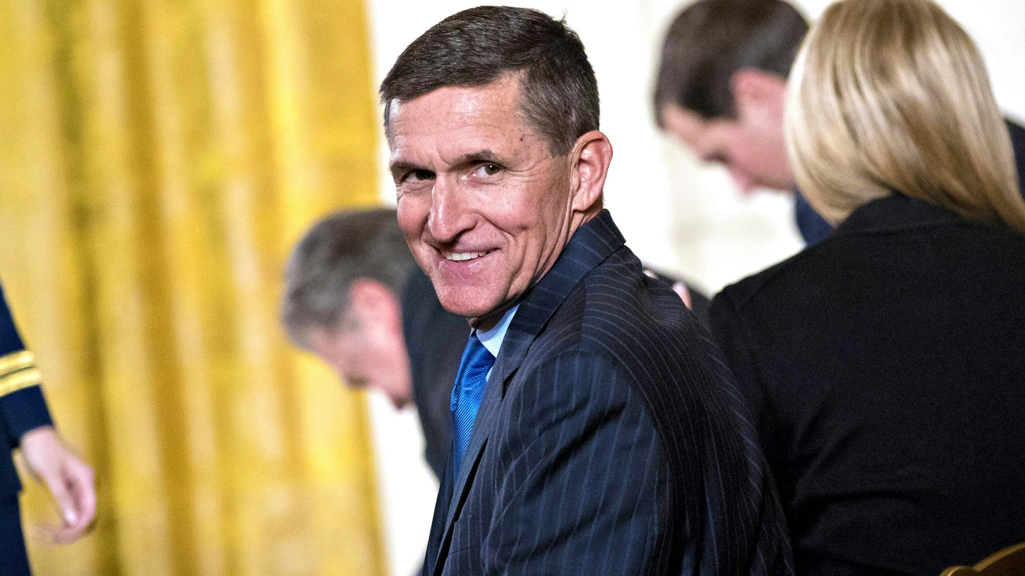 Retired Lieutenant General Michael Flynn, U.S. national security advisor, attends a swearing in ceremony of White House senior staff in the East Room of the White House in Washington, D.C., U.S., on Sunday, Jan. 22, 2017. Trump today mocked protesters who gathered for large demonstrations across the U.S. and the world on Saturday to signal discontent with his leadership, but later offered a more conciliatory tone, saying he recognized such marches as a hallmark of our democracy.