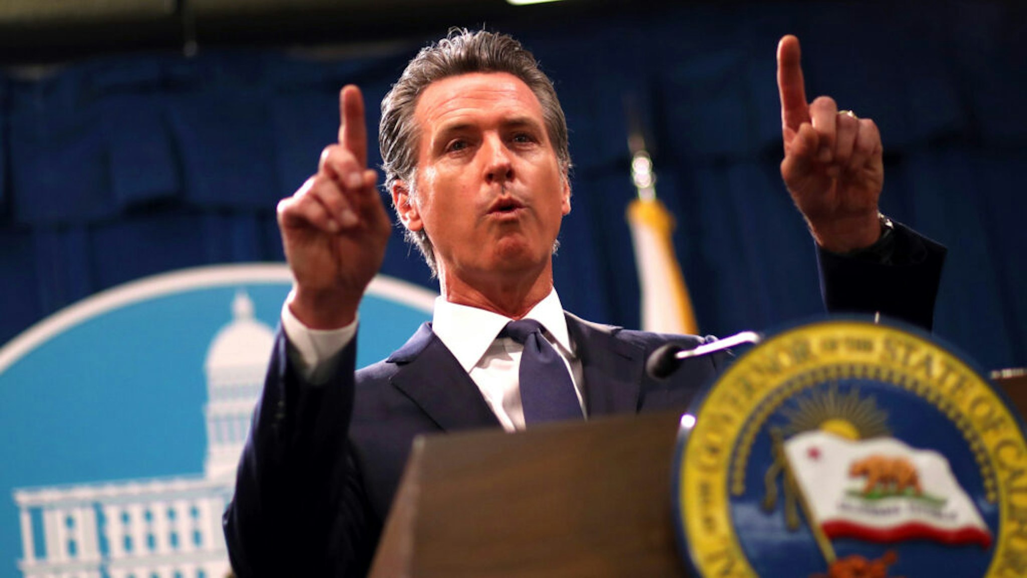 California Gov. Gavin Newsom speaks during a news conference with California attorney General Xavier Becerra at the California State Capitol on August 16, 2019 in Sacramento, California. California attorney genera Xavier Becerra and California Gov. Gavin Newsom announced that the State of California is suing the Trump administration challenging the legality of a new "public charge" rule that would make it difficult for immigrants to obtain green cards who receive public assistance like food stamps and Medicaid.