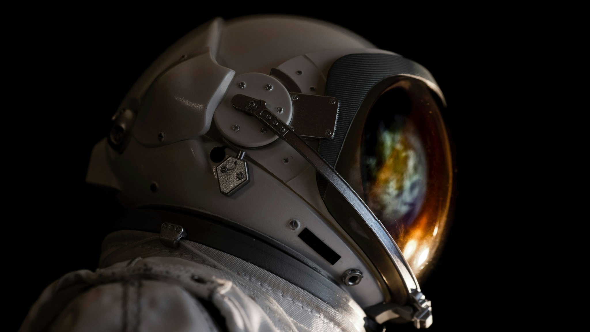 Close-Up Of Astronaut Against Black Background - stock photo