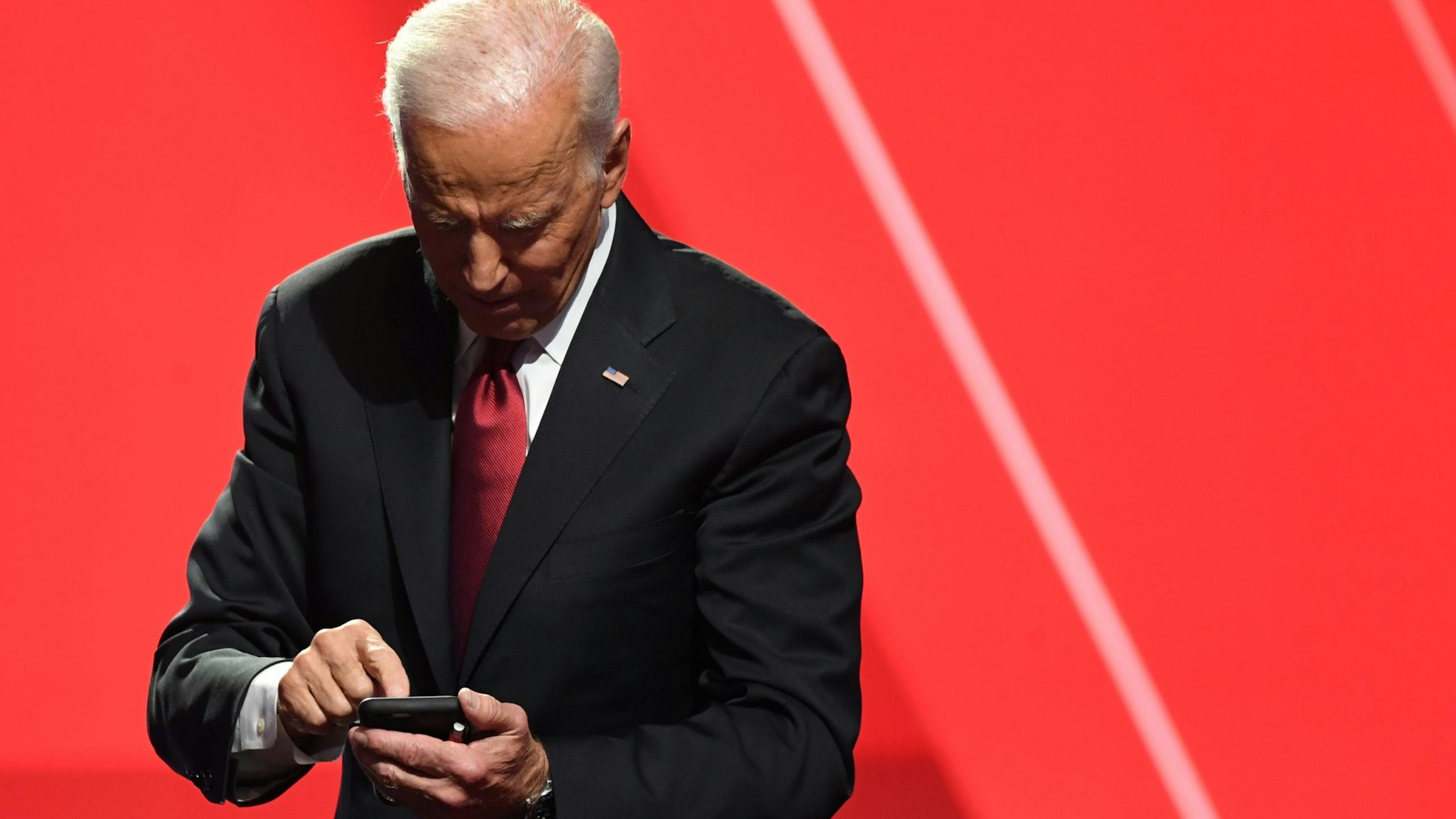 Democratic presidential hopeful former US Vice President Joe Biden looks at his phone after the fourth Democratic primary debate of the 2020 presidential campaign season co-hosted by The New York Times and CNN at Otterbein University in Westerville, Ohio on October 15, 2019. (Photo by SAUL LOEB / AFP) (Photo by SAUL LOEB/AFP via Getty Images)