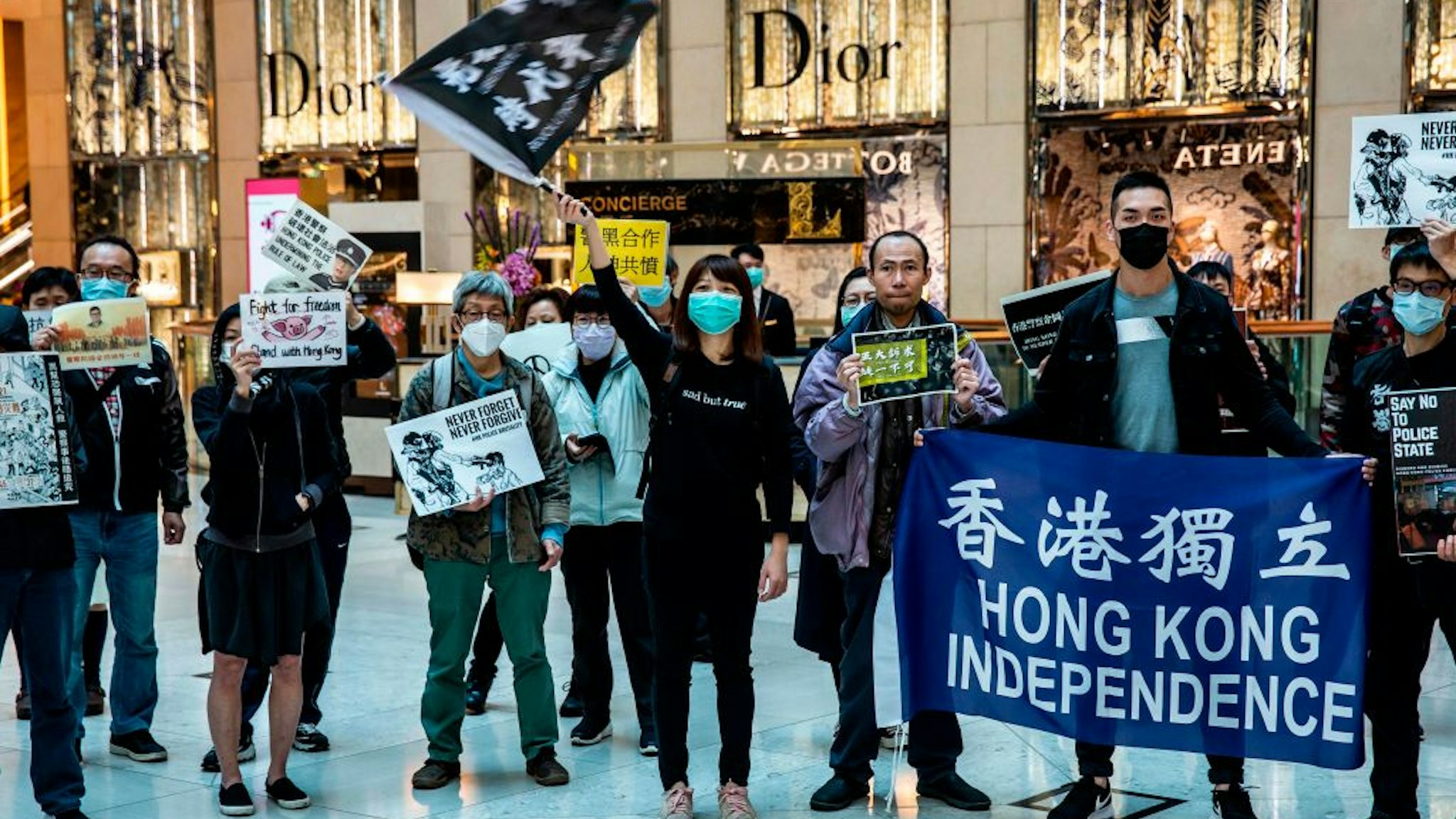 Office workers and protesters gather during a pro-democracy demonstration in a mall in the central district of Hong Kong on February 21, 2020.