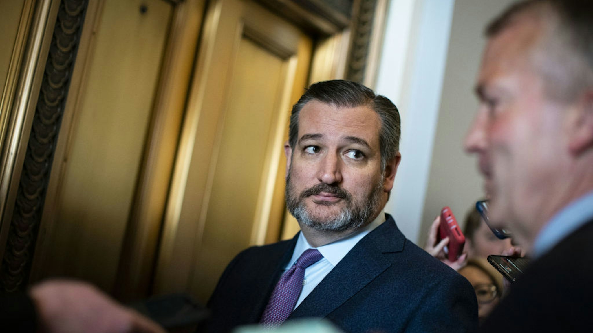 Senator Ted Cruz, a Republican from Texas, listens to a question while exiting a caucus meeting on Capitol Hill in Washington, D.C., U.S., on Wednesday, March 18, 2020.