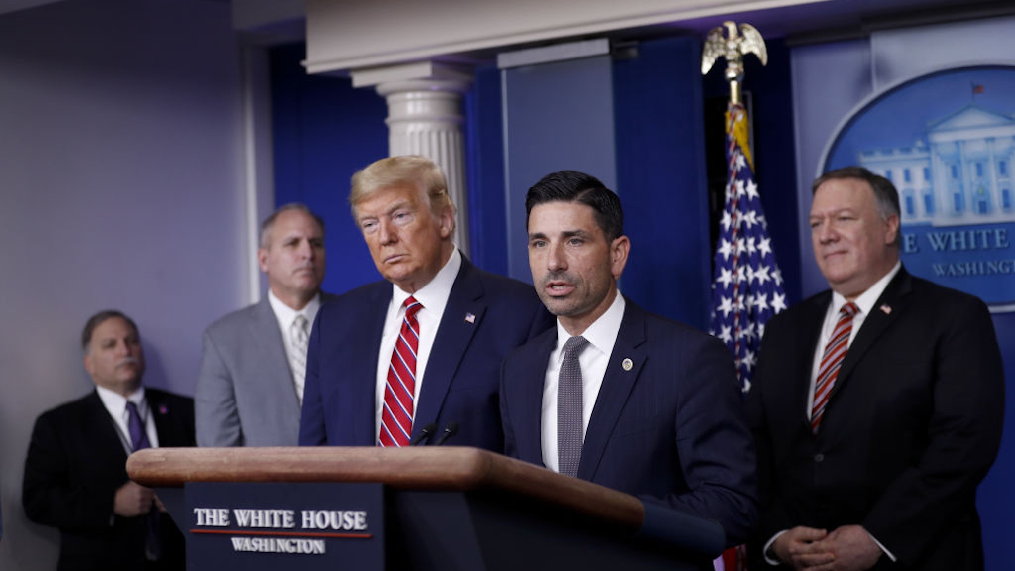 Chad Wolf, acting secretary of the Department of Homeland Security (DHS), center, speaks as U.S. President Donald Trump, third left, listens during a Coronavirus Task Force news conference in the briefing room of the White House in Washington, D.C., U.S., on Friday, March 20, 2020.