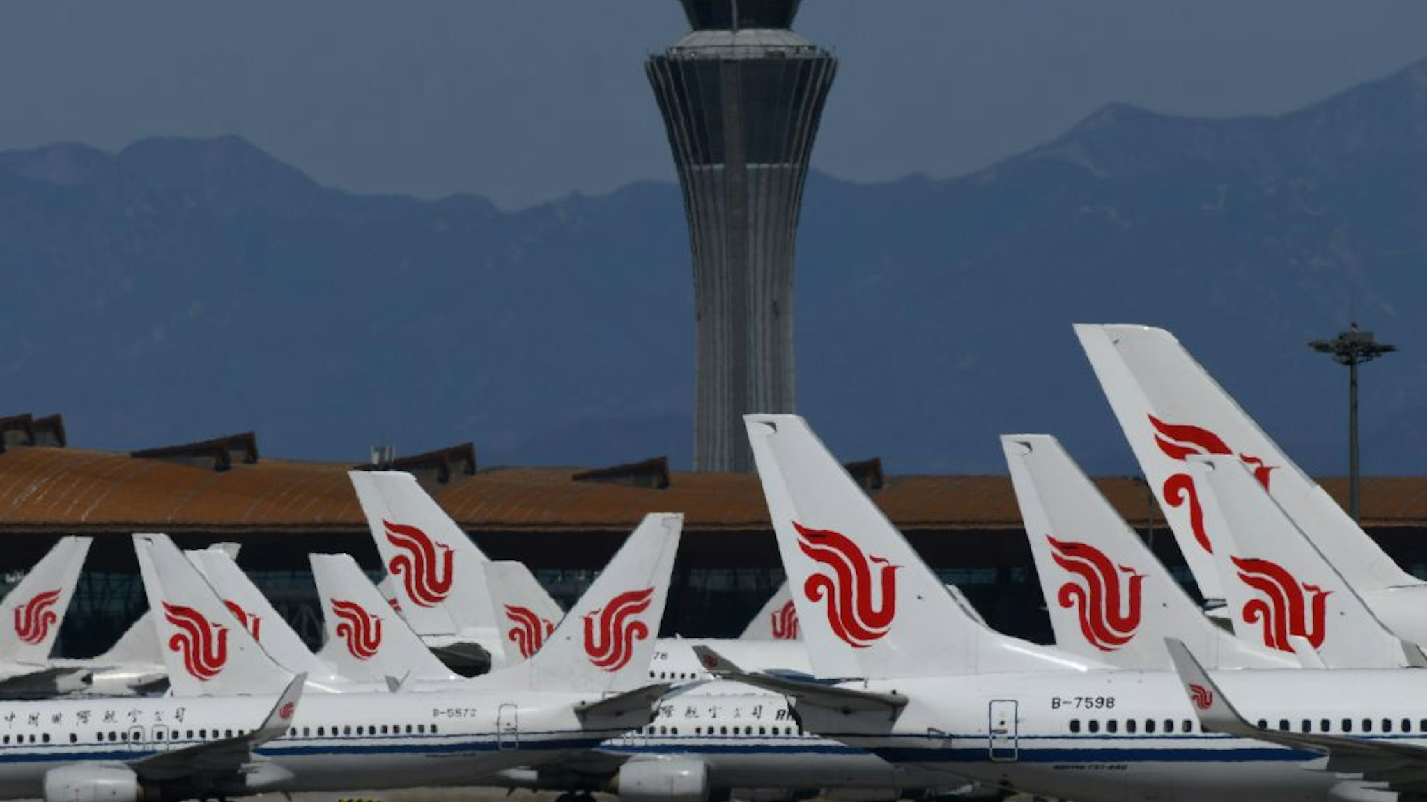Air China planes are seen parked on the tarmac at Beijing Capital Airport on March 27, 2020.