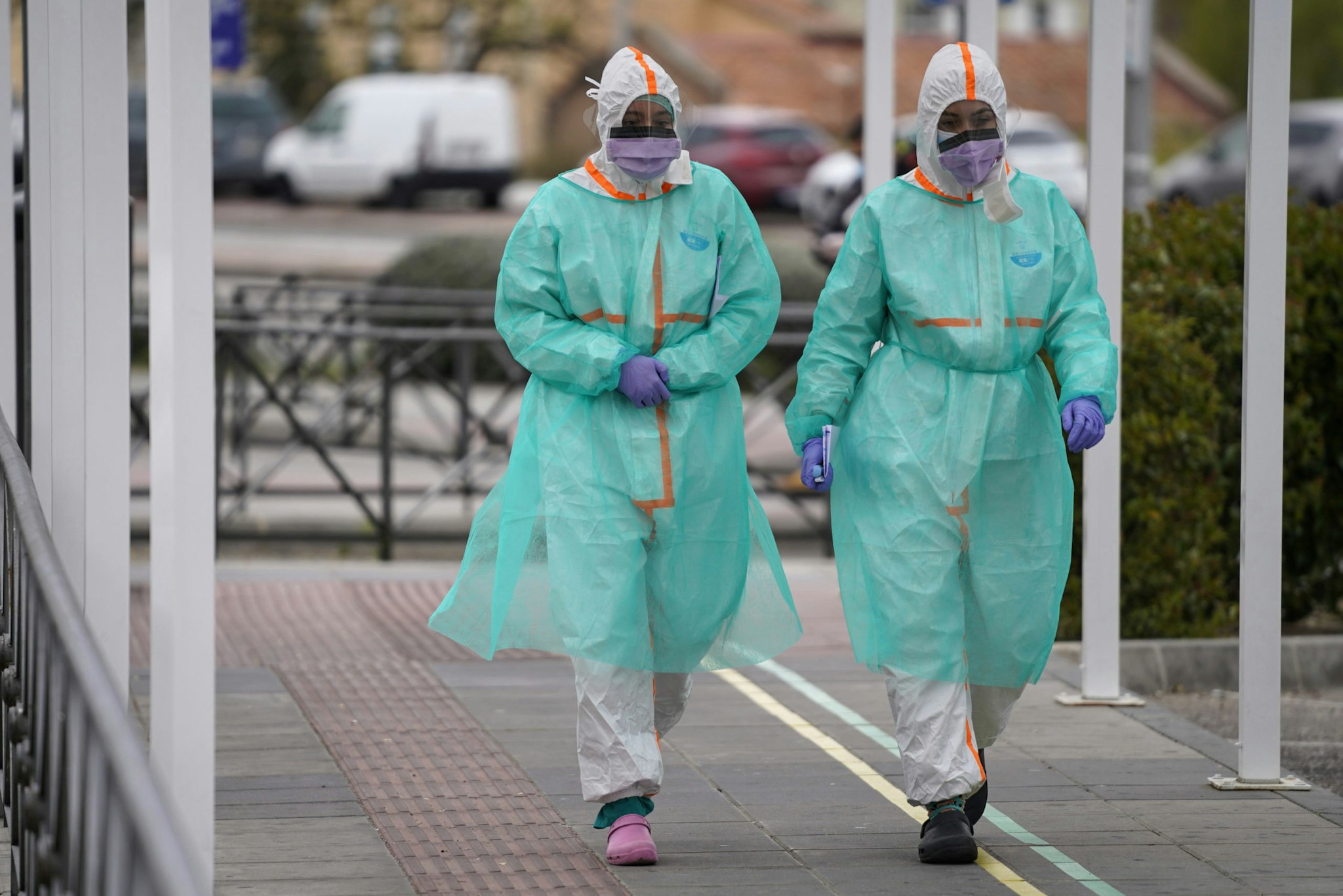 Medical workers wearing protective face masks and full body outfits walk outside the emergency department of the 12 de Octubre hospital in Madrid, Spain, on Monday, March 30, 2020. Spain suffered its deadliest day yet of the coronavirus outbreak this weekend as Prime Minister Pedro Sanchez convened an emergency cabinet meeting to try to chart a way out of the crisis rapidly engulfing the nation. Photographer: Paul Hanna/Bloomberg via Getty Images