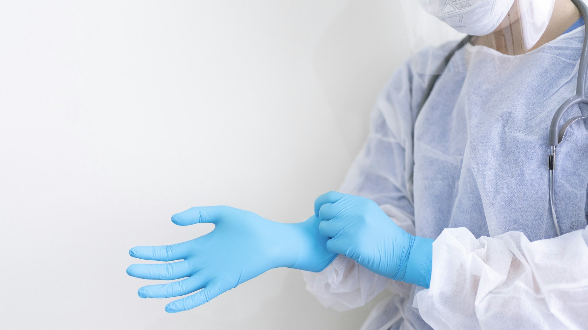 Doctor wearing PPE Suite (Personal Protection Equipment)holding serum glass tube Concept of coronavirus quarantine - stock photo