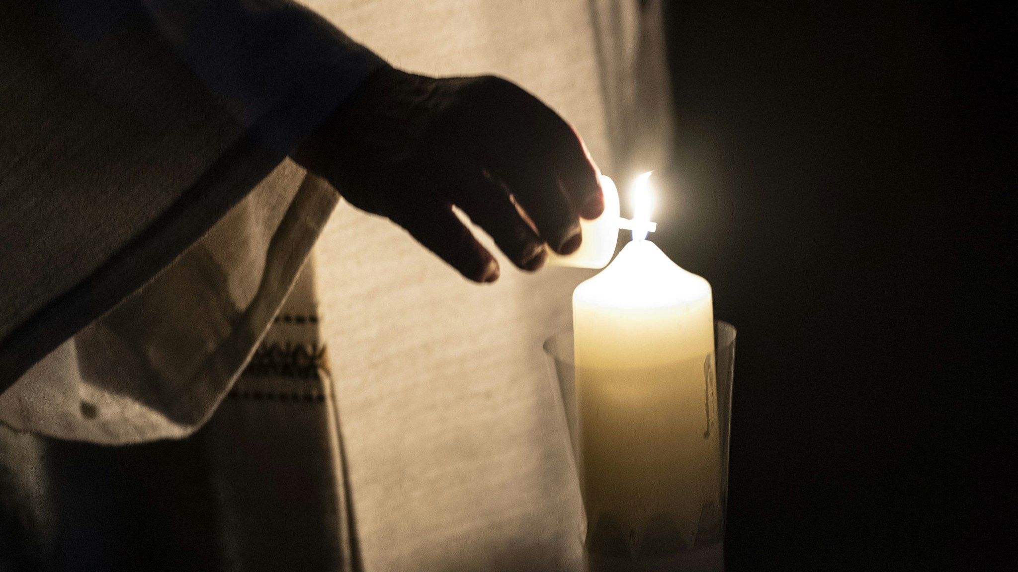 11 April 2020, Baden-Wuerttemberg, St. Peter: Pastor Klemens Armbruster lights a candle in the monastery church. Because of the coronavirus pandemic, the Easter Vigil services are held without an audience. Photo: Patrick Seeger/dpa (Photo by Patrick Seeger/picture alliance via Getty Images)