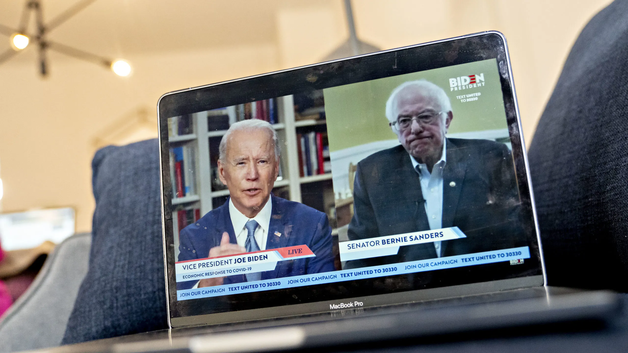 ormer Vice President Joe Biden, presumptive Democratic presidential nominee, left, speaks as Senator Bernie Sanders, an Independent from Vermont, right, listens during a virtual event seen on an Apple Inc. laptop computer in Arlington, Virginia, U.S., on Monday, April 13, 2020. Sanders endorsed Biden during the joint livestream saying that Americans of all political affiliations should back the former vice president. Photographer: Andrew Harrer/Bloomberg via Getty Images