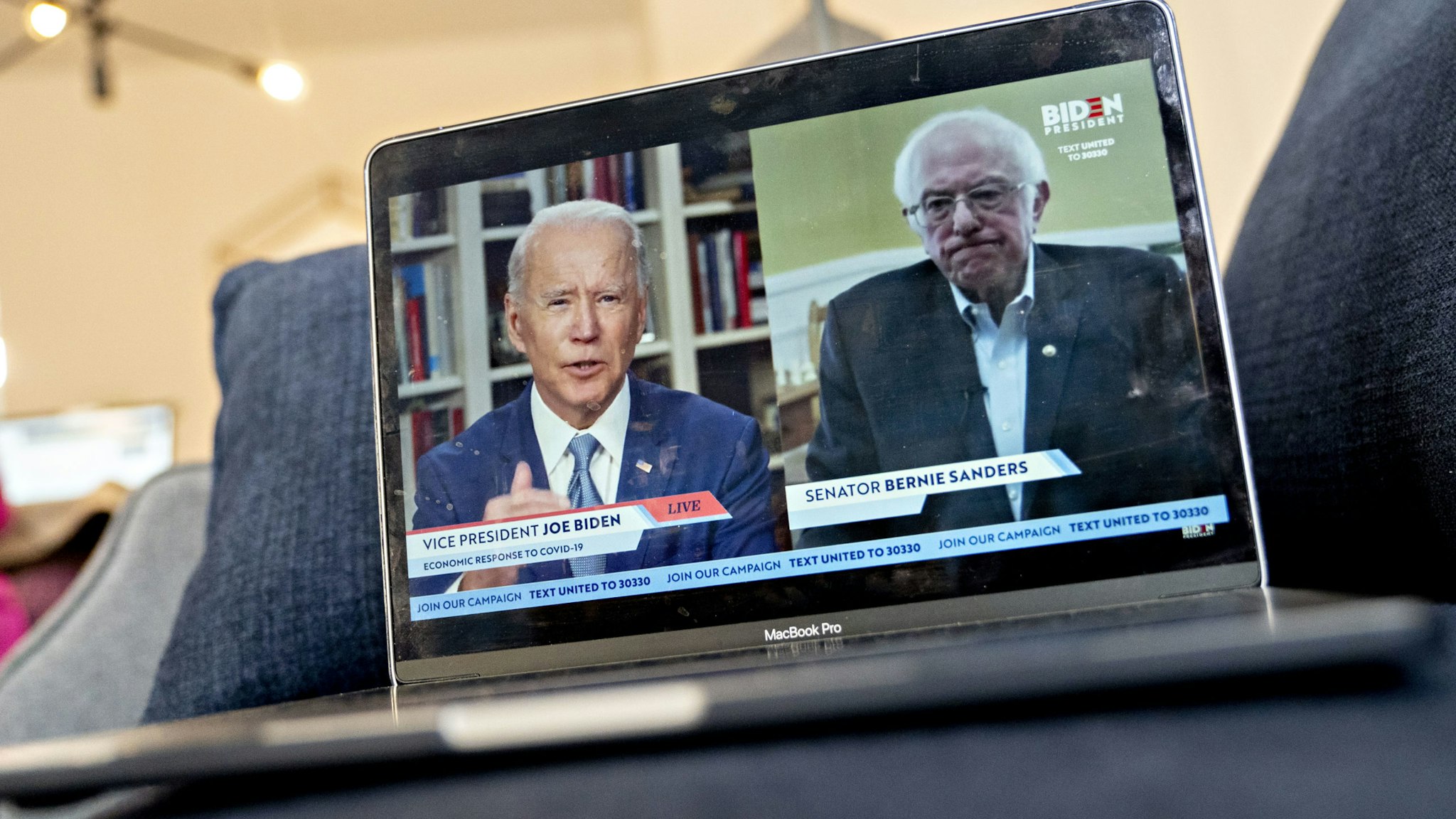 ormer Vice President Joe Biden, presumptive Democratic presidential nominee, left, speaks as Senator Bernie Sanders, an Independent from Vermont, right, listens during a virtual event seen on an Apple Inc. laptop computer in Arlington, Virginia, U.S., on Monday, April 13, 2020. Sanders endorsed Biden during the joint livestream saying that Americans of all political affiliations should back the former vice president. Photographer: Andrew Harrer/Bloomberg via Getty Images