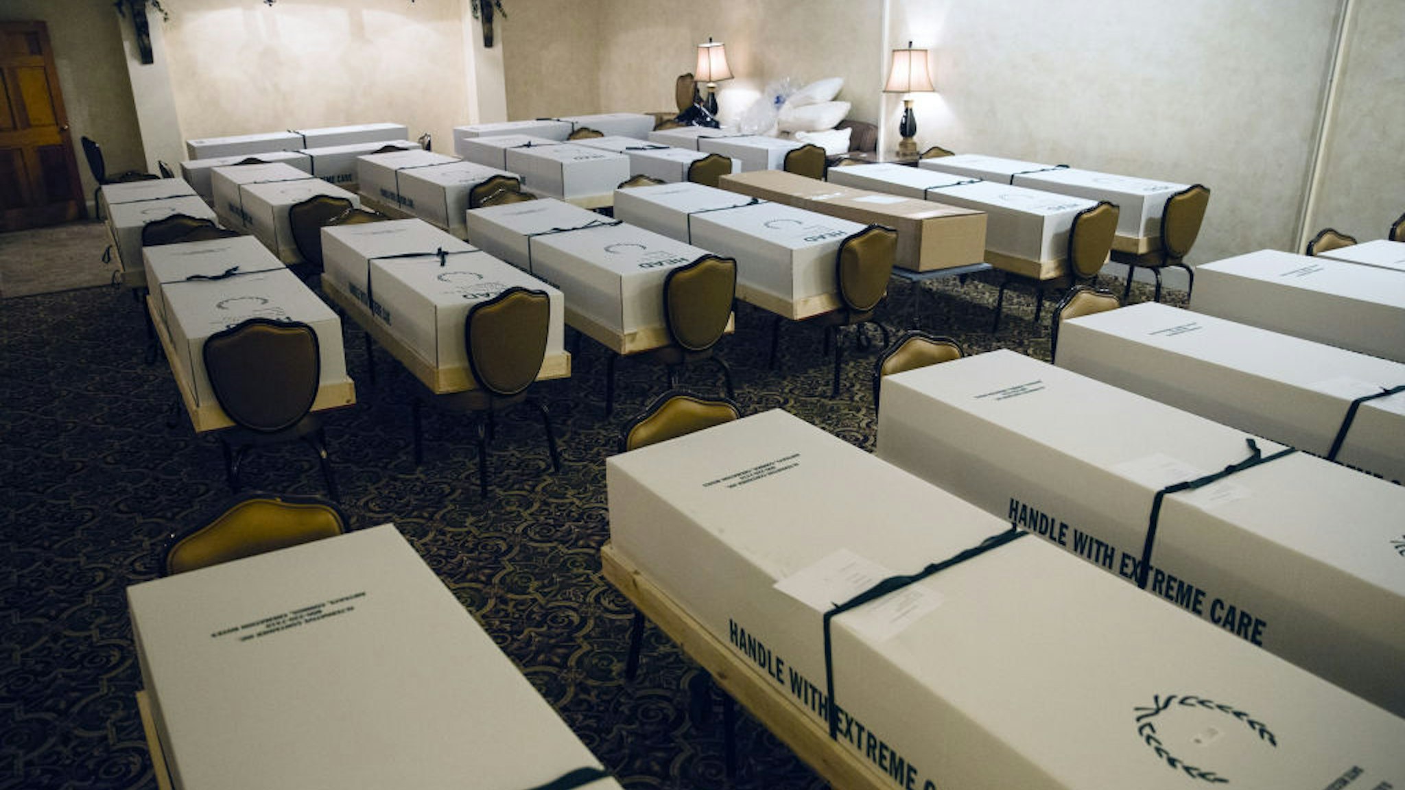 Cremation boxes, mostly containing the bodies of suspected covid-19 patients, sit in a room at a funeral home in the Queens borough of New York, U.S., on Wednesday, April 29, 2020.