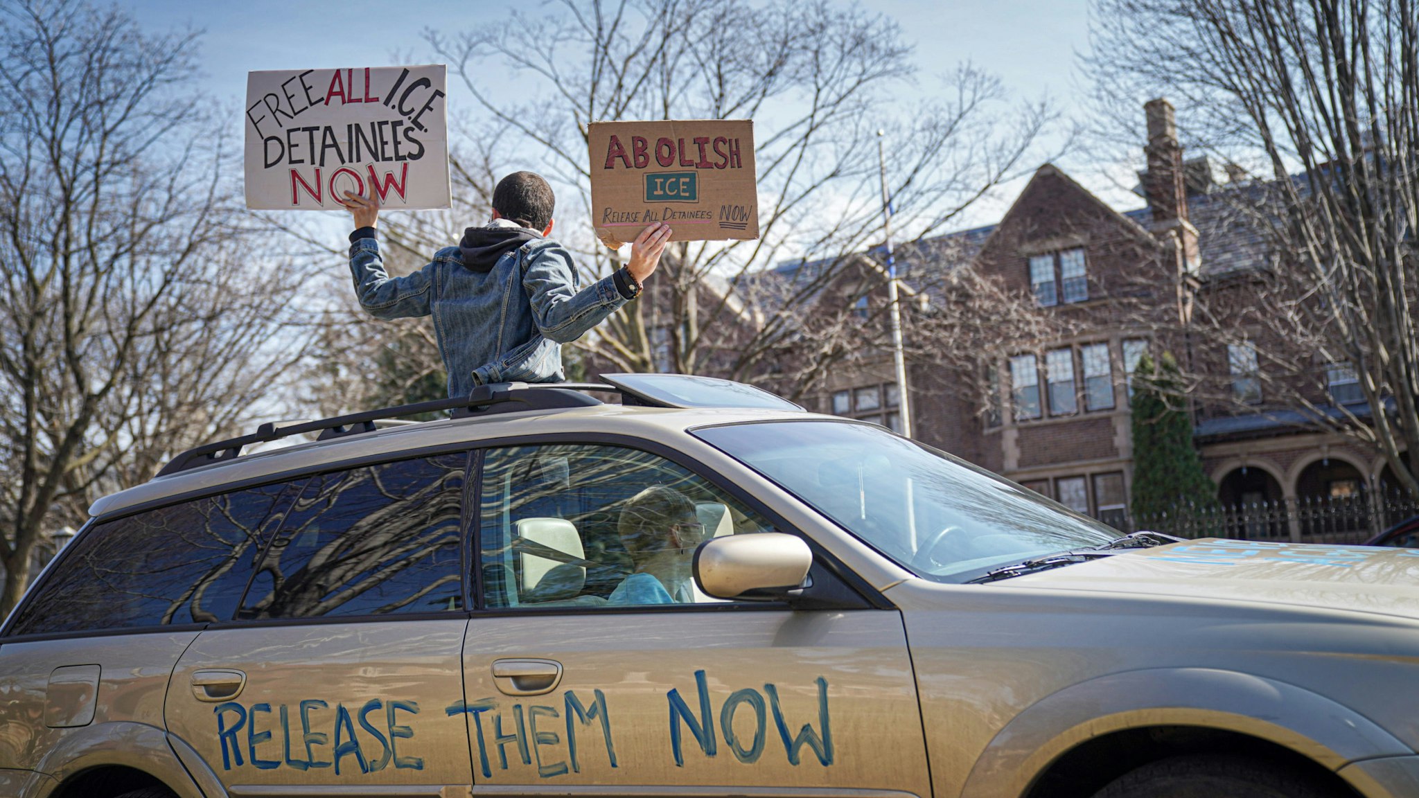 St Paul, MN March 27: Activists who stayed mostly in their cars for social distancing, lined Summit Ave, honking horns outside the Governor's Residence in St Paul. The were calling for the release of high risk prisoners and ICE detainees from MN facilities to lower the chances of infection. (Photo by Glen Stubbe/Star Tribune via Getty Images)