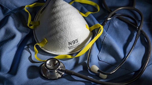 N95 Face Mask with Stethoscope and Scrubs - stock photo
