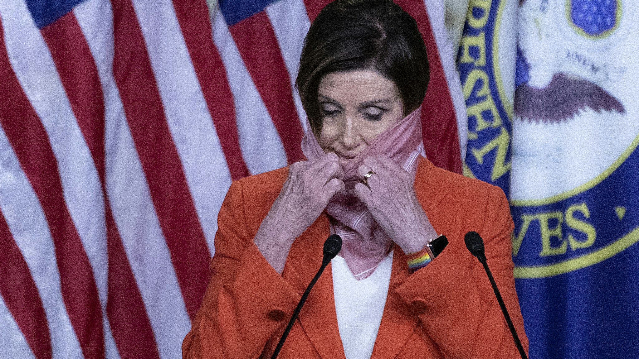 WASHINGTON, DC - APRIL 24: Speaker of the House Nancy Pelosi (D-CA) pulls down her scarf as she beings her weekly news conference during the novel coronavirus pandemic at the U.S. Capitol April 24, 2020 in Washington, DC. President Donald Trump is expected to sign a bipartisan $484 billion coronavirus relief package to restart a depleted small business loan program and to provide funds for hospitals and COVID-19 testing. (Photo by Chip Somodevilla/Getty Images)