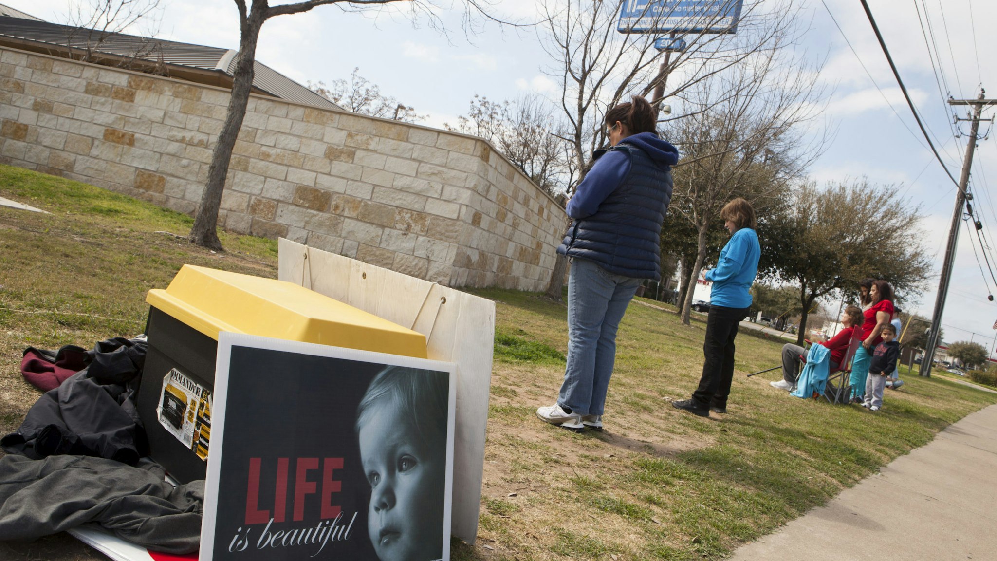 AUSTIN, TEXAS - FEBRUARY 22: Anti-abortion, pro-life activists pray outside a Planned Parenthood clinic that offers abortions, on February 22, 2016 in Austin, Texas. They sign up to pray at the vigil for one hour each in support of a campaign called 'Forty Days for Life.' At least two people will be at the vigil for forty days during daylight hours. After the passage of a restrictive abortion bill in the Texas legislature, HB2, both sides of the abortion debate are active in getting their positions known. The US Supreme Court will rule on whether to overturn the bill. (Photo by Melanie Stetson Freeman/The Christian Science Monitor via Getty Images)