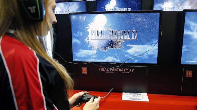 PARIS, FRANCE - OCTOBER 28: A woman plays the video game "Final Fantasy XV" developed and published by Square Enix during the "Paris Games Week" on October 28, 2016 in Paris, France. "Paris Games Week" is an international trade fair for video games to be held from October 27 to October 31, 2016. (Photo by Chesnot/Getty Images)