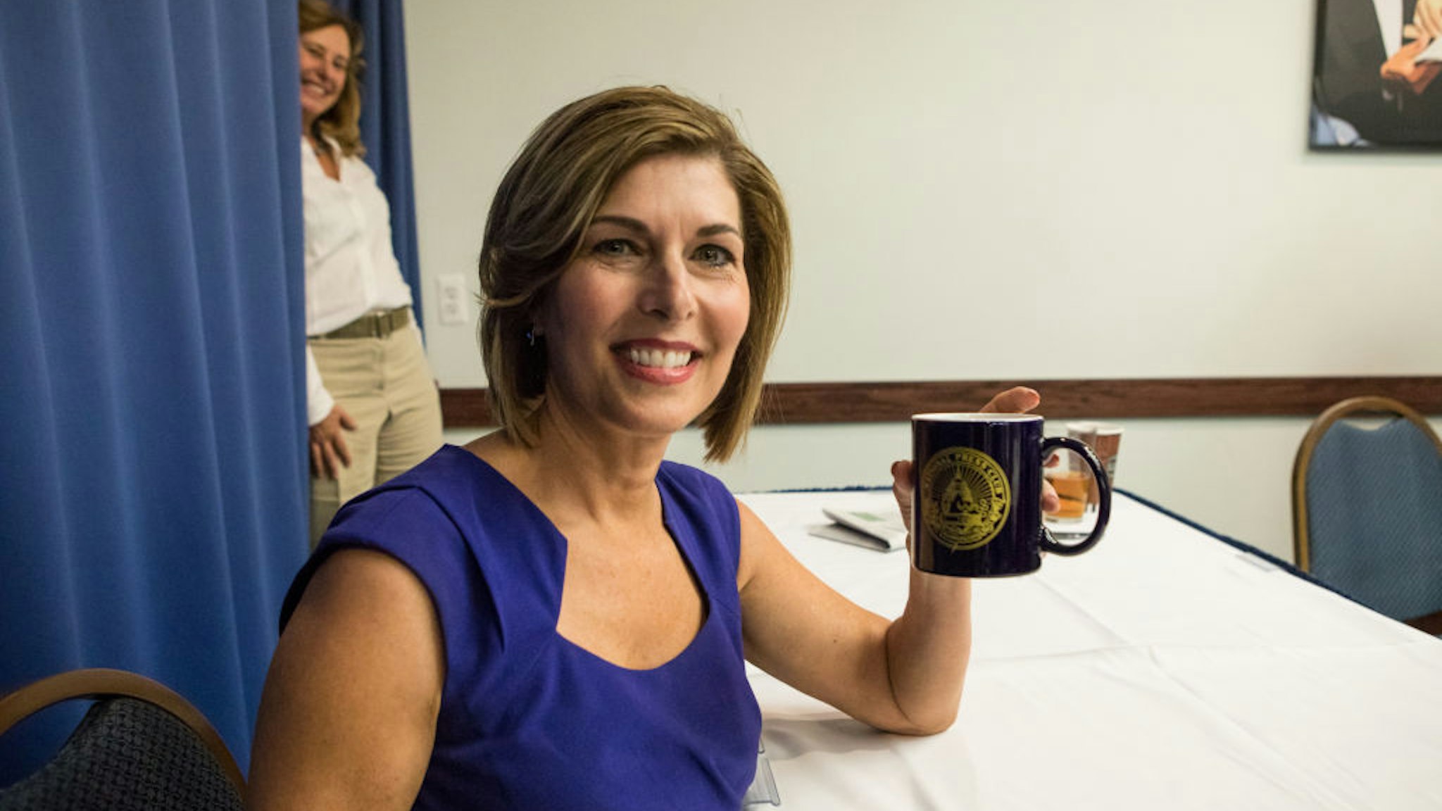 Former CBS News Correspondent Sharyl Attkisson, author of The Smear: How Shady Political Operatives and Fake News Control What You See, What You Think and How You Vote, holds up her National Press Club coffee mug, at the Club's Headliners Book Event in Washington, D.C., on Thursday, August 31, 2017.