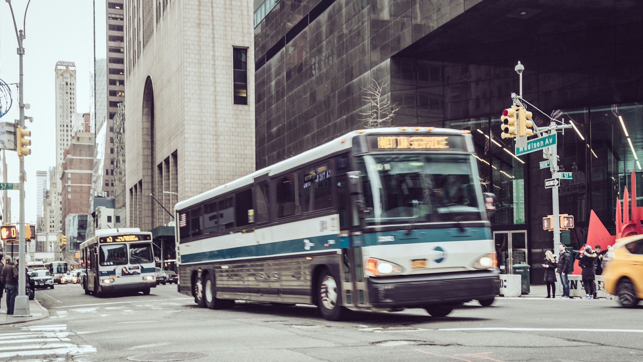 Public transportation buses on Fifth Avenue , Midtown Manhattan, Midtown Manhattan .
