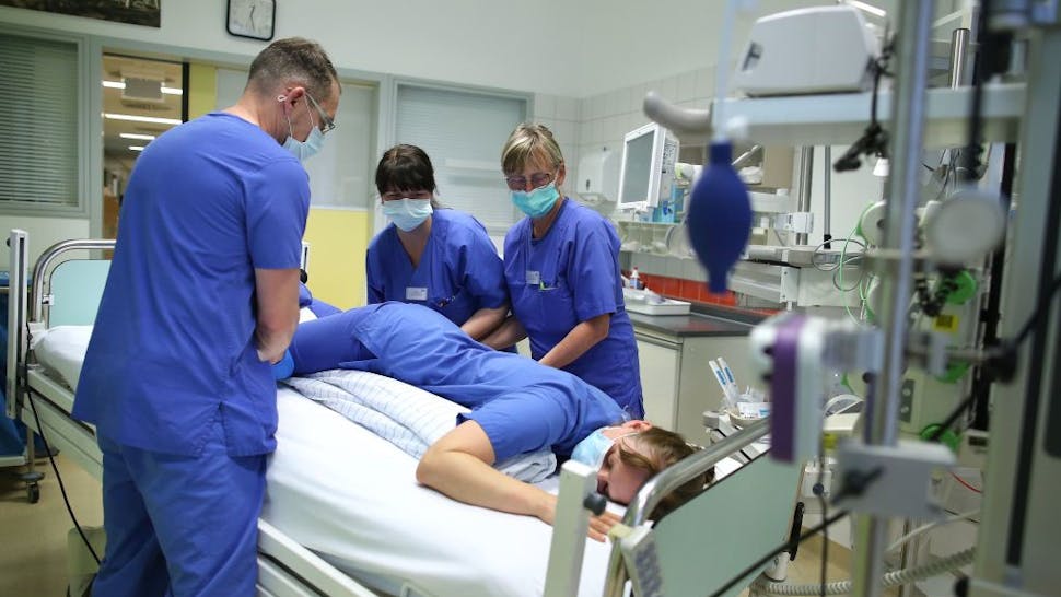 Hospital staff in Germany Nurse Carla Stuermer (3rd L) coaches medical staff how to reposition Covid-19 patients in the intensive care unit of the community hospital in Magdeburg, eastern Germany, on April 16, 2020 during the novel coronavirus COVID-19 pandemic. (Photo by Ronny Hartmann / AFP) (Photo by RONNY HARTMANN/AFP via Getty Images)
