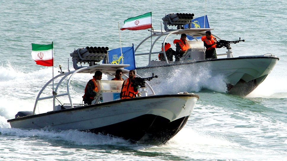 (COMBO) This combination of file pictures created on July 22, 2019 shows Iranian Revolutionary Guards driving speedboats at the port of Bandar Abbas on July 02, 2012 (L), and the amphibious assault ship USS Boxer (LHD 4) as transiting the East Sea during exercises on March 7, 2016. - Iran's seizure of a British-flagged oil tanker in the Strait of Hormuz was a "legal measure", the spokesman for the Islamic republic's government said on July 22. Iran impounded the Stena Impero tanker on allegations it failed to respond to distress calls and turned off its transponder after hitting a fishing boat. (Photos by Atta KENARE and Craig Z. Rodarte / various sources / AFP) / RESTRICTED TO EDITORIAL USE - MANDATORY CREDIT "AFP PHOTO /US NAVY/GREG Z RODARTE" - NO MARKETING NO ADVERTISING CAMPAIGNS - DISTRIBUTED AS A SERVICE TO CLIENTS