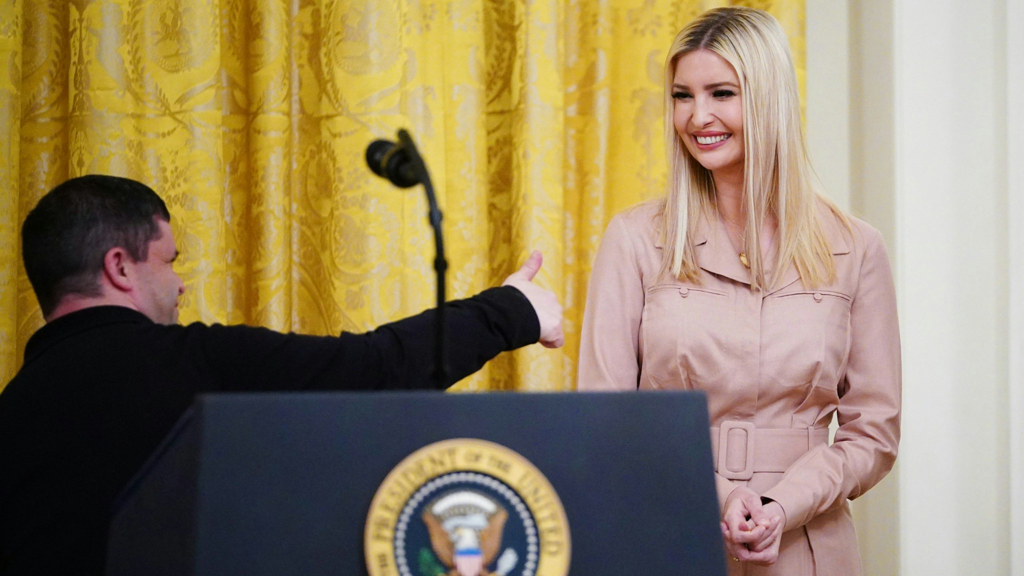 Bitty &amp; Beau's Coffee employee Michael Heup (L) gives the thumbs-up as White House Advisor Ivanka Trump watches during a press briefing in the East Room of the White House in Washington, DC, on April 28, 2020. - US President Donald Trump held a press briefing about supporting small businesses during the coronavirus pandemic through the Paycheck Protection Program.