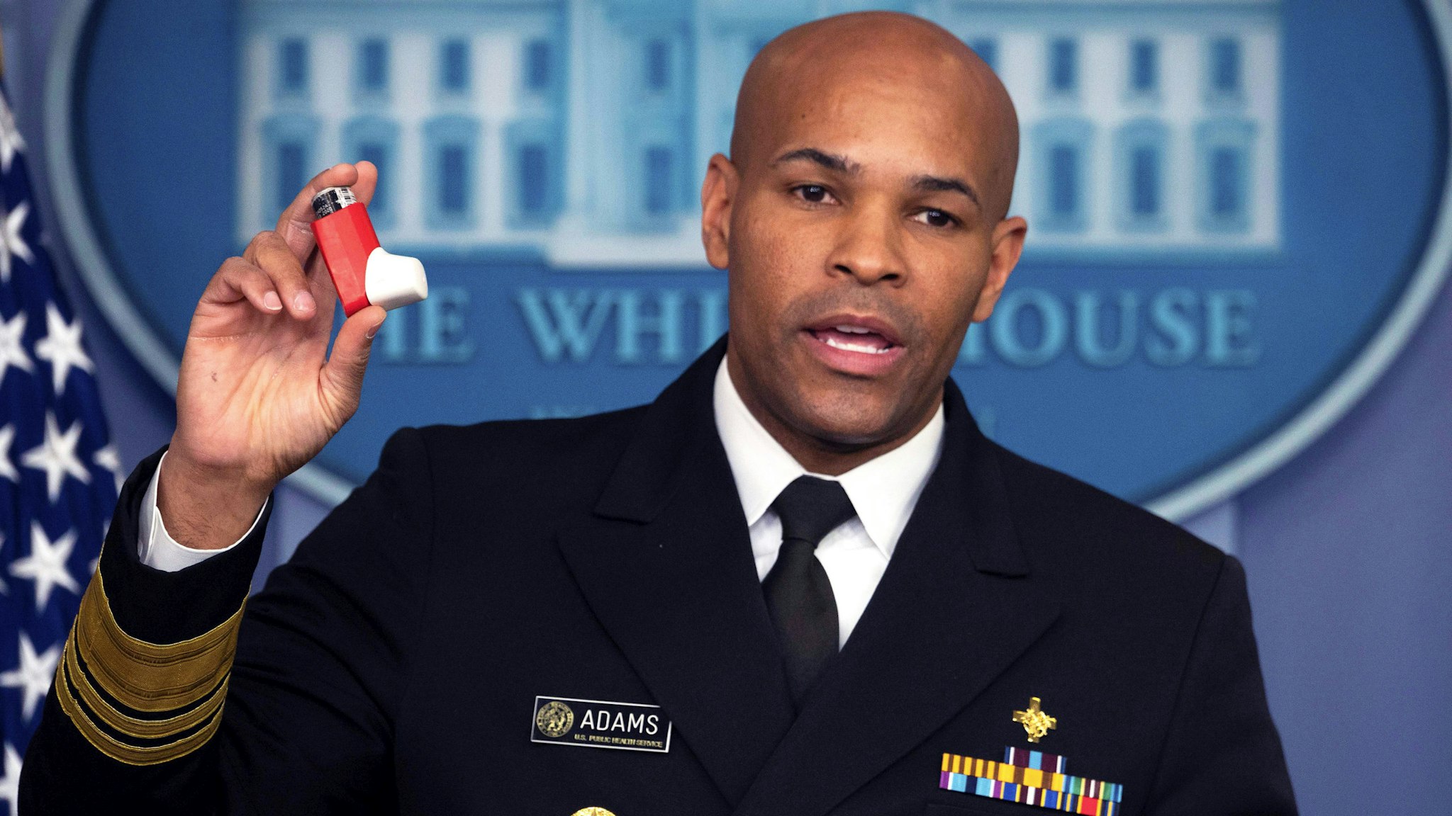US Surgeon General Jerome Adams shows his inhaler as speaks during the daily briefing on the novel coronavirus, which causes COVID-19, in the Brady Briefing Room at the White House on April 10, 2020, in Washington, DC.
