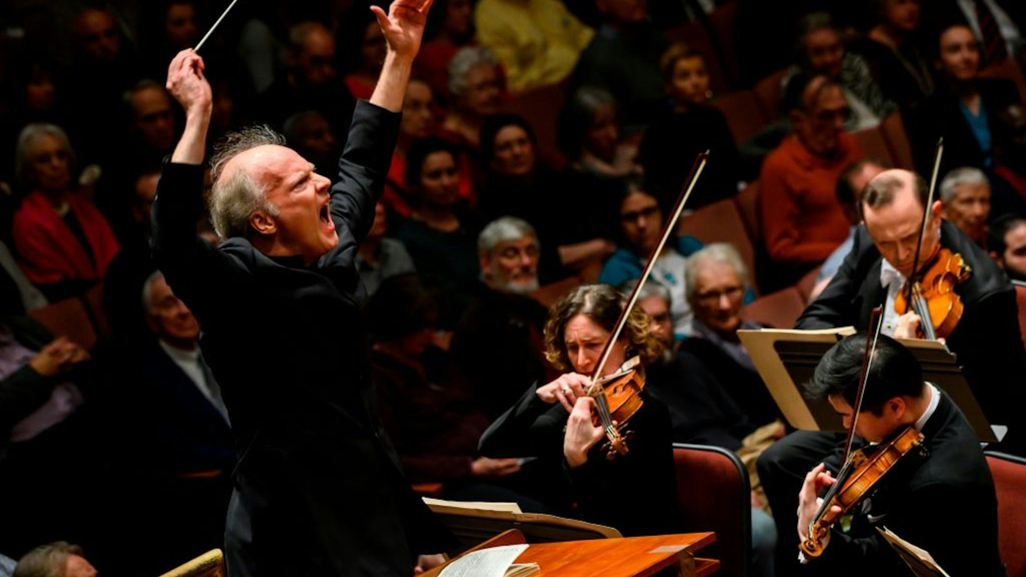 Italian conductor Gianandrea Noseda conducts the National Symphony Orchestra (NSO) during a concert at the John F. Kennedy Center for the Performing Arts in Washington DC, on February 14, 2019. - In the concert hall, the sound is crisp, slicing through the air like a sharp knife. Gianandrea Noseda's baton is a divining rod that draws fresh energy from a once sluggish National Symphony Orchestra. He holds the promise of turning around the NSO much like he did with the Teatro Regio, a once relatively unknown provincial ensemble that became an internationally acclaimed one. The NSO, in turn, rewards Noseda with a foothold in the United Staees.