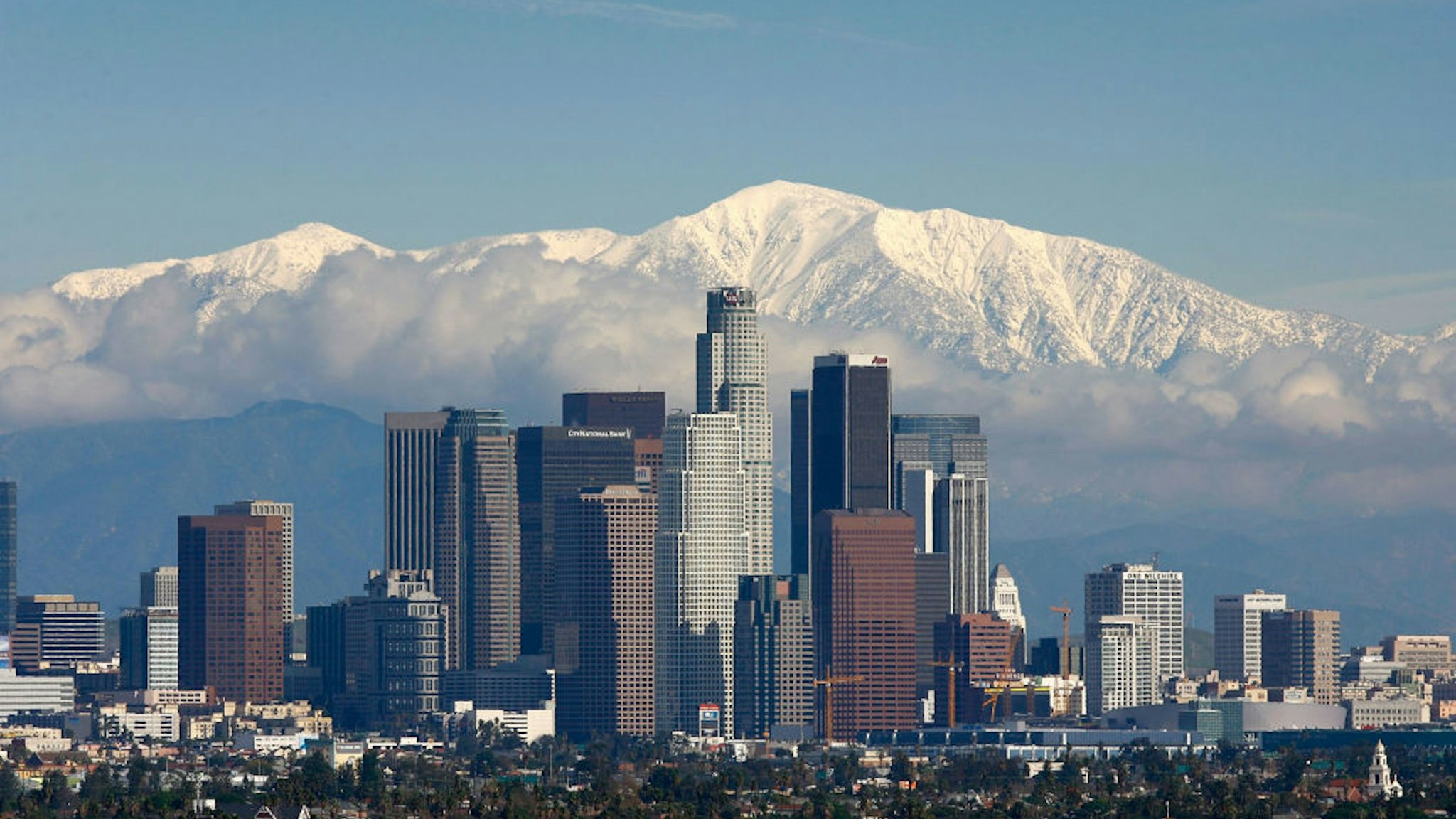 LOS ANGELES, CA - JANUARY 7: Fresh snow blankets the mountains behind the downtown skyline after a series of storms that hammered northern California delivered much needed precipitation to the Greater Los Angeles Area January 7, 2008 in Los Angeles, California. With the threat of mandatory water rationing still in effect because of prolonged drought, the rain is a small step toward relief. Forecasters had predicted flash floods and mudslides near large areas that were denuded by wildfires of historic proportions in October, and some mandatory evacuations were declared, but little damage was reported.