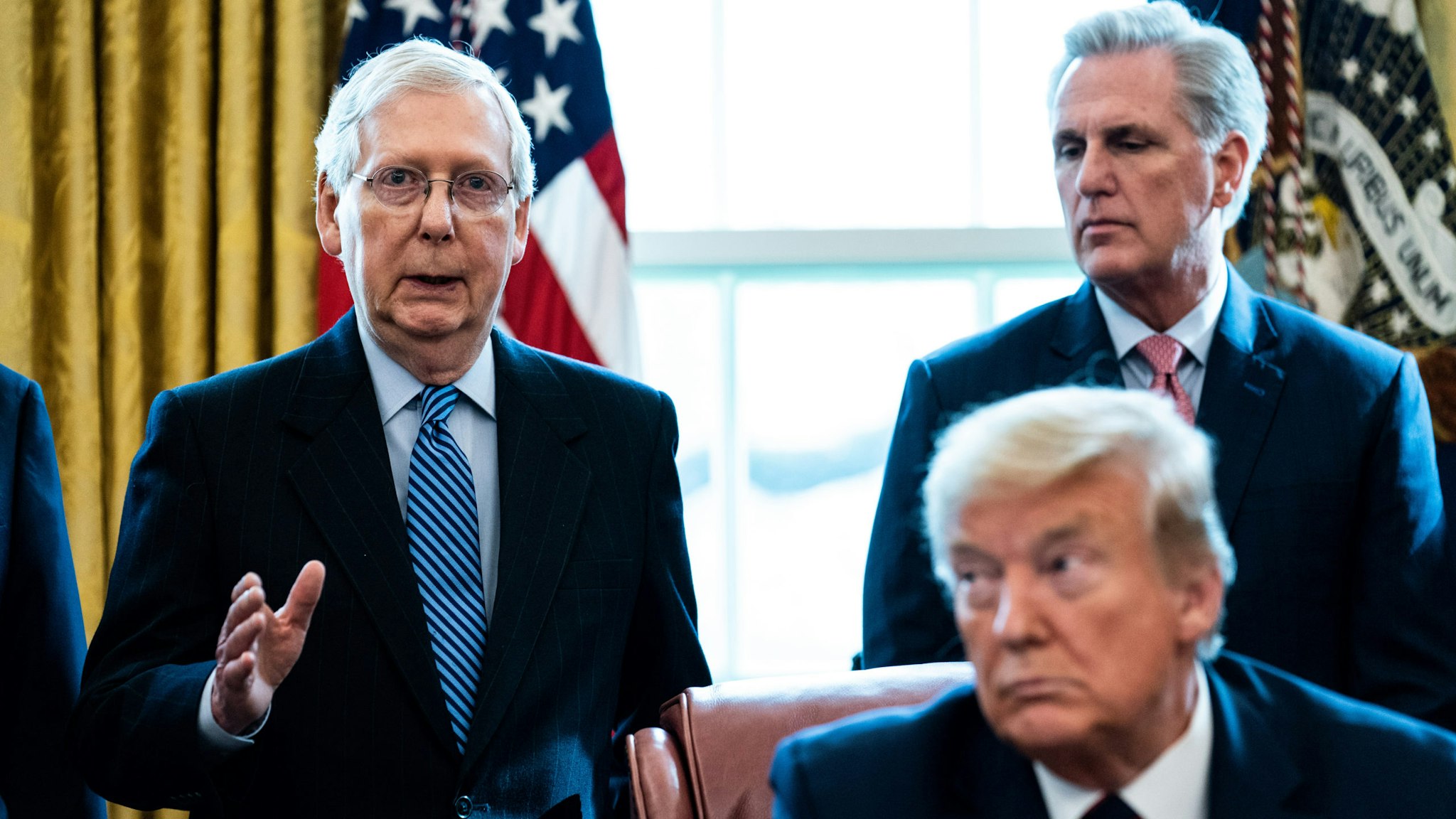 WASHINGTON, DC - MARCH 27: (L-R) Senate Majority Leader Mitch McConnell (R-KY) speaks as House Minority Leader Kevin McCarthy (R-CA) U.S. President Donald Trump listen during a signing ceremony for H.R. 748, the CARES Act in the Oval Office of the White House on March 27, 2020 in Washington, DC. Earlier on Friday, the U.S. House of Representatives approved the $2 trillion stimulus bill that lawmakers hope will battle the the economic effects of the COVID-19 pandemic.