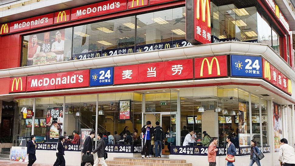 Pedestrians walk past a McDonald’s restaurant in Guangzhou, Tianhe McDonald's, Guangzhou, China, on Wednesday, April 4, 2007.