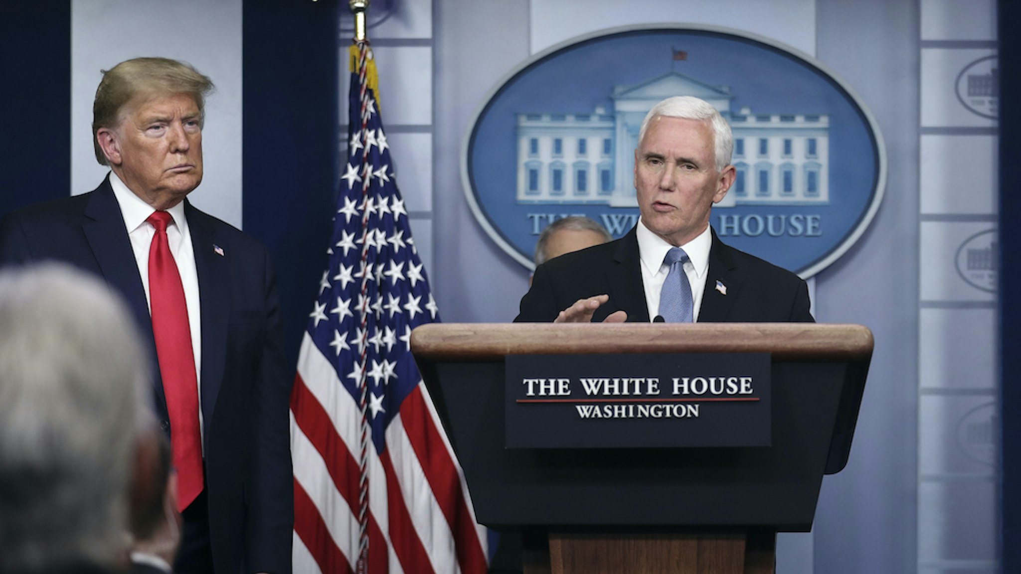 U.S. Vice President Mike Pence speaks as President Donald Trump, left, and Larry Kudlow, director of the U.S. National Economic Council, right, listen during a Coronavirus Task Force news conference in the briefing room of the White House in Washington, D.C., U.S., on Tuesday, March 24, 2020. Trump said he envisions “packed” U.S. churches on Easter Sunday as he described his ambition to abandon stringent public-health measures to combat the coronavirus outbreak and re-open the economy in mid-April. Photographer: Oliver Contreras/SIPA/Bloomberg