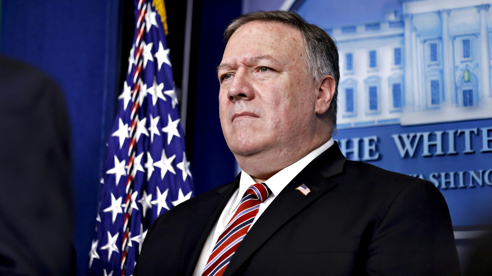 Mike Pompeo, U.S. secretary of state, listens during a Coronavirus Task Force news conference in the briefing room of the White House in Washington, D.C., U.S., on Friday, March 20, 2020. Americans will have to practice social distancing for at least several more weeks to mitigate U.S. cases of Covid-19, Anthony S. Fauci of the National Institutes of Health said today.