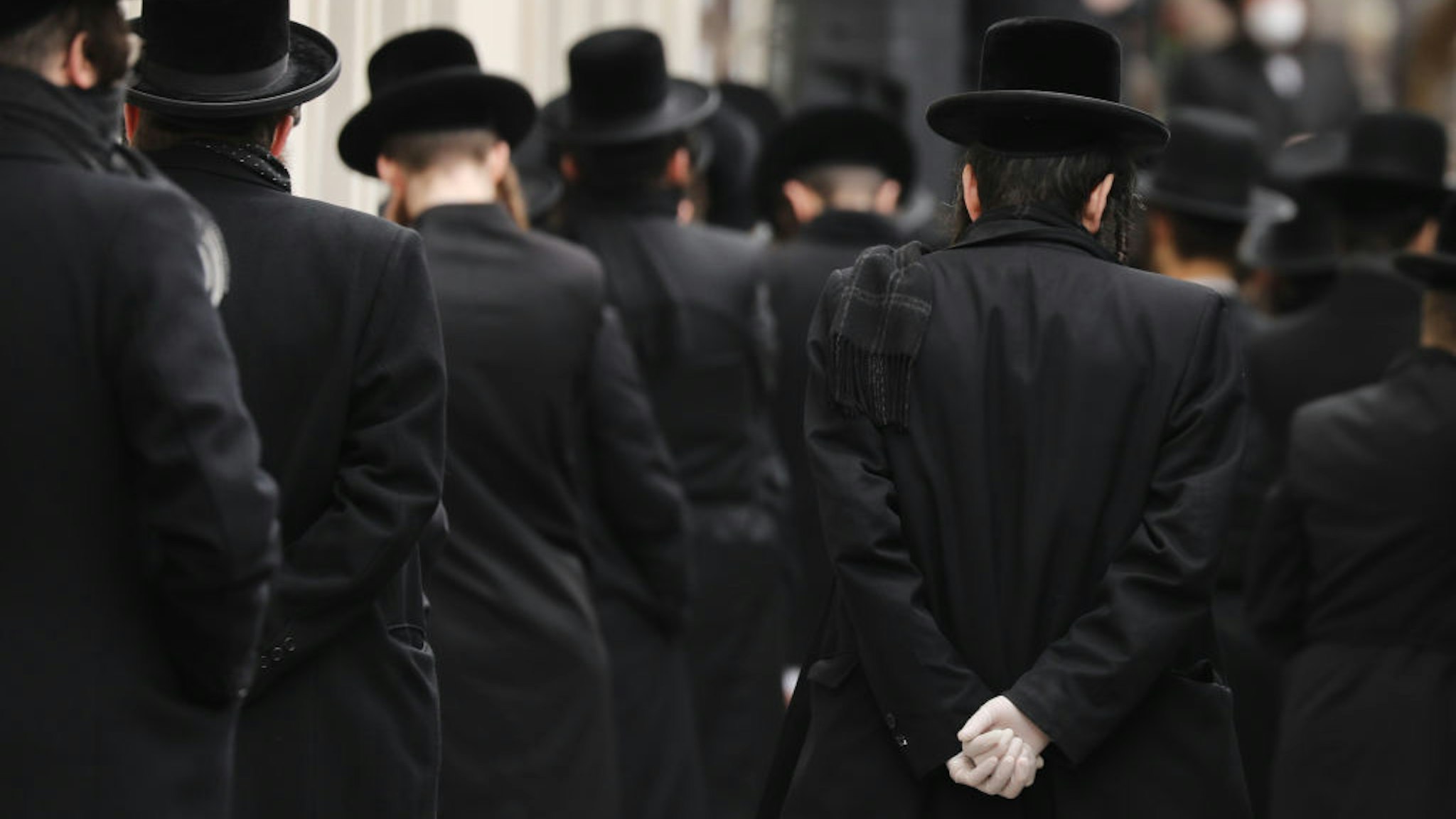 Hundreds of members of the Orthodox Jewish community attend the funeral for a rabbi who died from the coronavirus in the Borough Park neighborhood which has seen an upsurge of (COVID-19) patients during the pandemic on April 05, 2020 in the Brooklyn Borough of New York City. Hospitals in New York City, which has been especially hard hit by the coronavirus, are facing shortages of beds, ventilators and protective equipment for medical staff. Currently, over 122,000 New Yorkers have tested positive for coronavirus. (Photo by Spencer Platt/Getty Images)