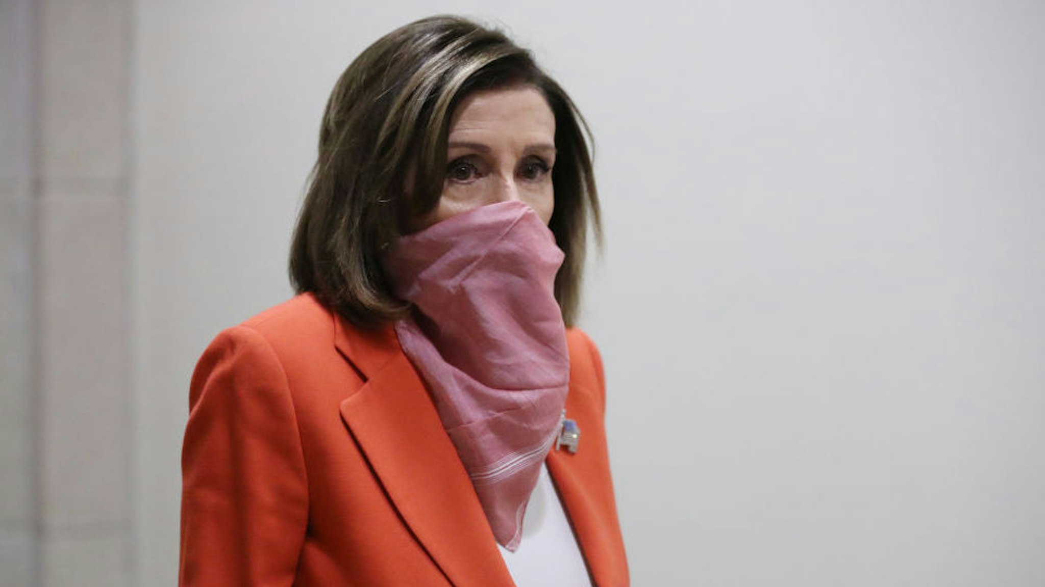 Speaker of the House Nancy Pelosi (D-CA) wears a scarf over her mouth and nose as she arrives for her weekly news conference during the novel coronavirus pandemic at the U.S. Capitol April 24, 2020 in Washington, DC. President Donald Trump is expected to sign a bipartisan $484 billion coronavirus relief package to restart a depleted small business loan program and to provide funds for hospitals and COVID-19 testing. (Photo by Chip Somodevilla/Getty Images)