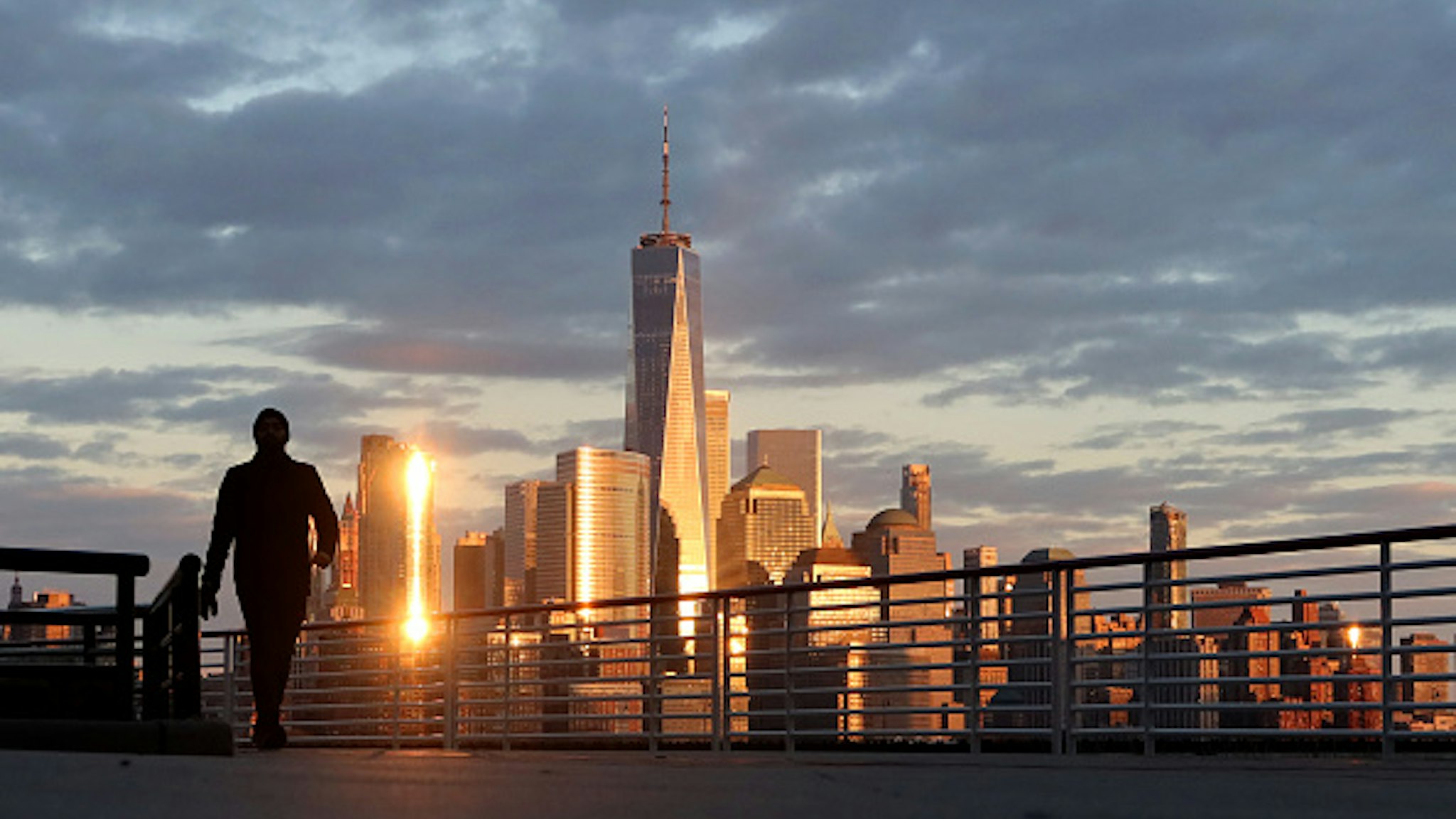 JERSEY CITY, NJ - APRIL 4: The sun sets on the skyline of lower Manhattan and One World Trade Center in New York City on April 4, 2020 as seen from Jersey City, New Jersey.