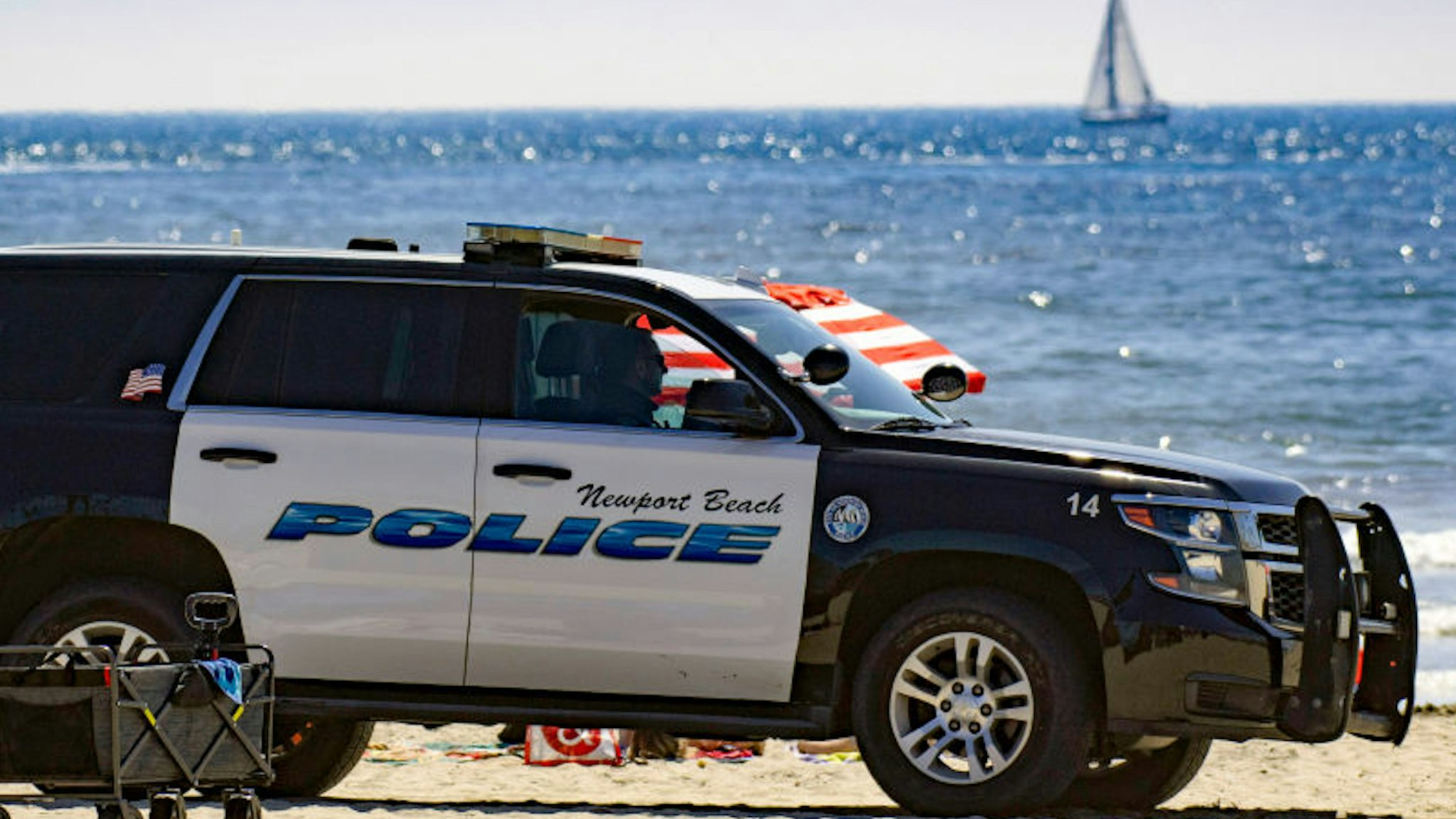 NEWPORT BEACH, CA - APRIL 25: Newport Beach Police patrol near the pier as thousands enjoy a day at the beach on Saturday, April 25, 2020.