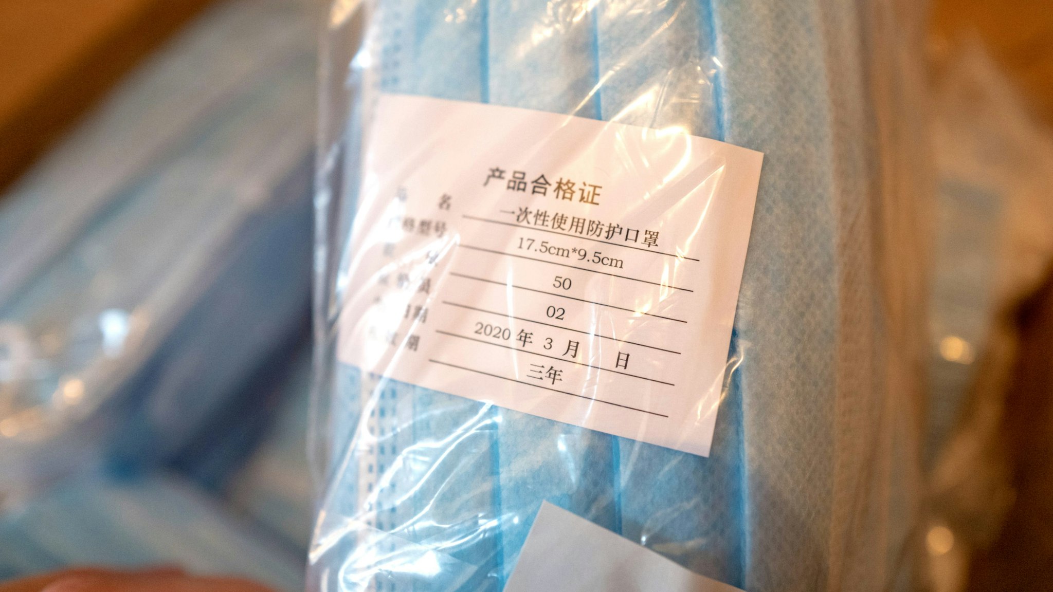 Close-up of a cardboard box filled with packaged blue surgical masks imported from China during an outbreak of the COVID-19 coronavirus in San Ramon, California, April 5, 2020.