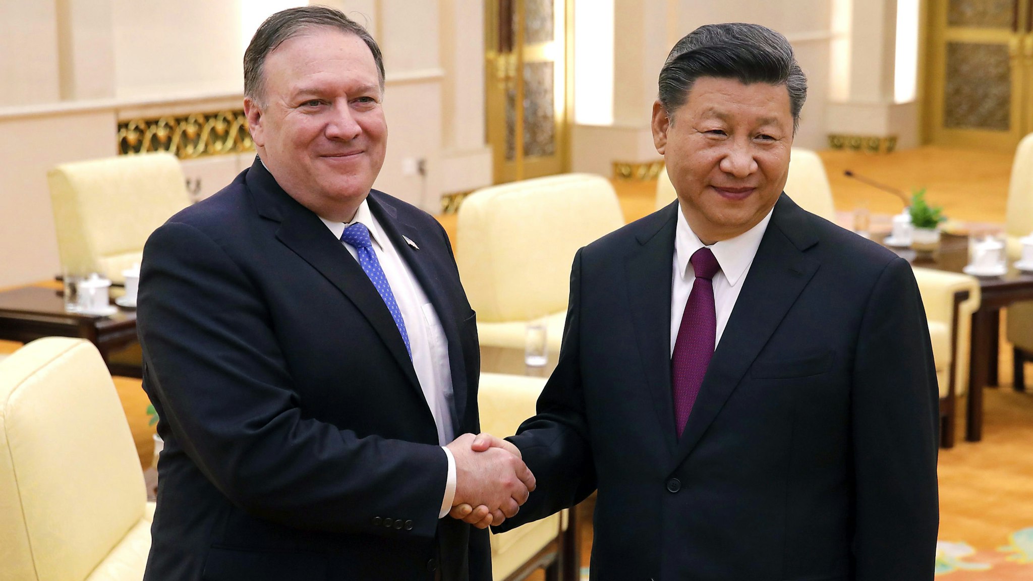 US Secretary of State Mike Pompeo (L) shakes hands with Chinese President Xi Jinping as they pose for photograph at the Great Hall of the People in Beijing on June 14, 2018.